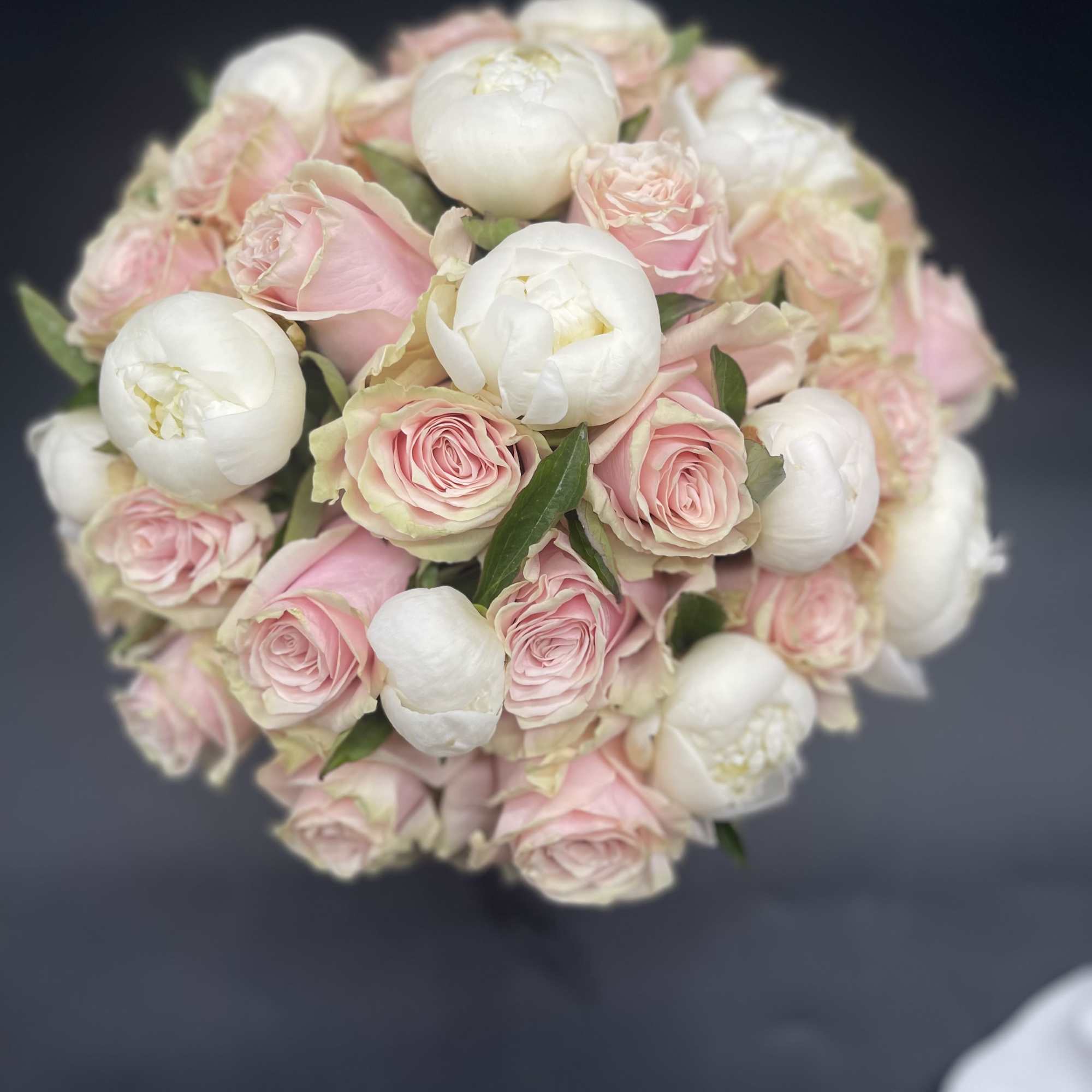 Round bouquet of pale pink roses and white peonies