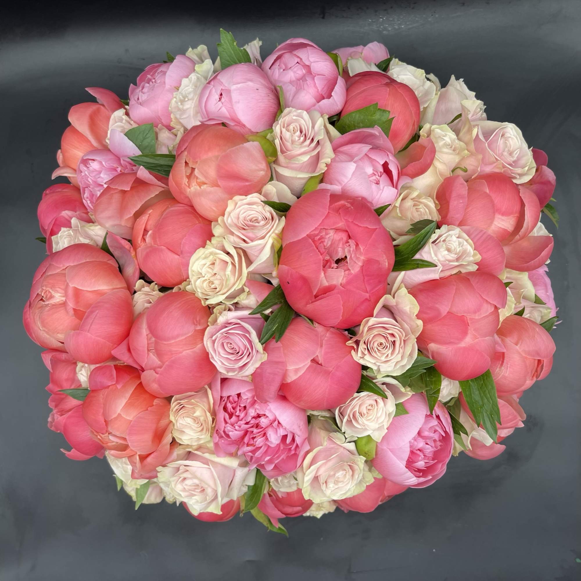 30 pink peonies surrounded by 50 stunning roses in a a white