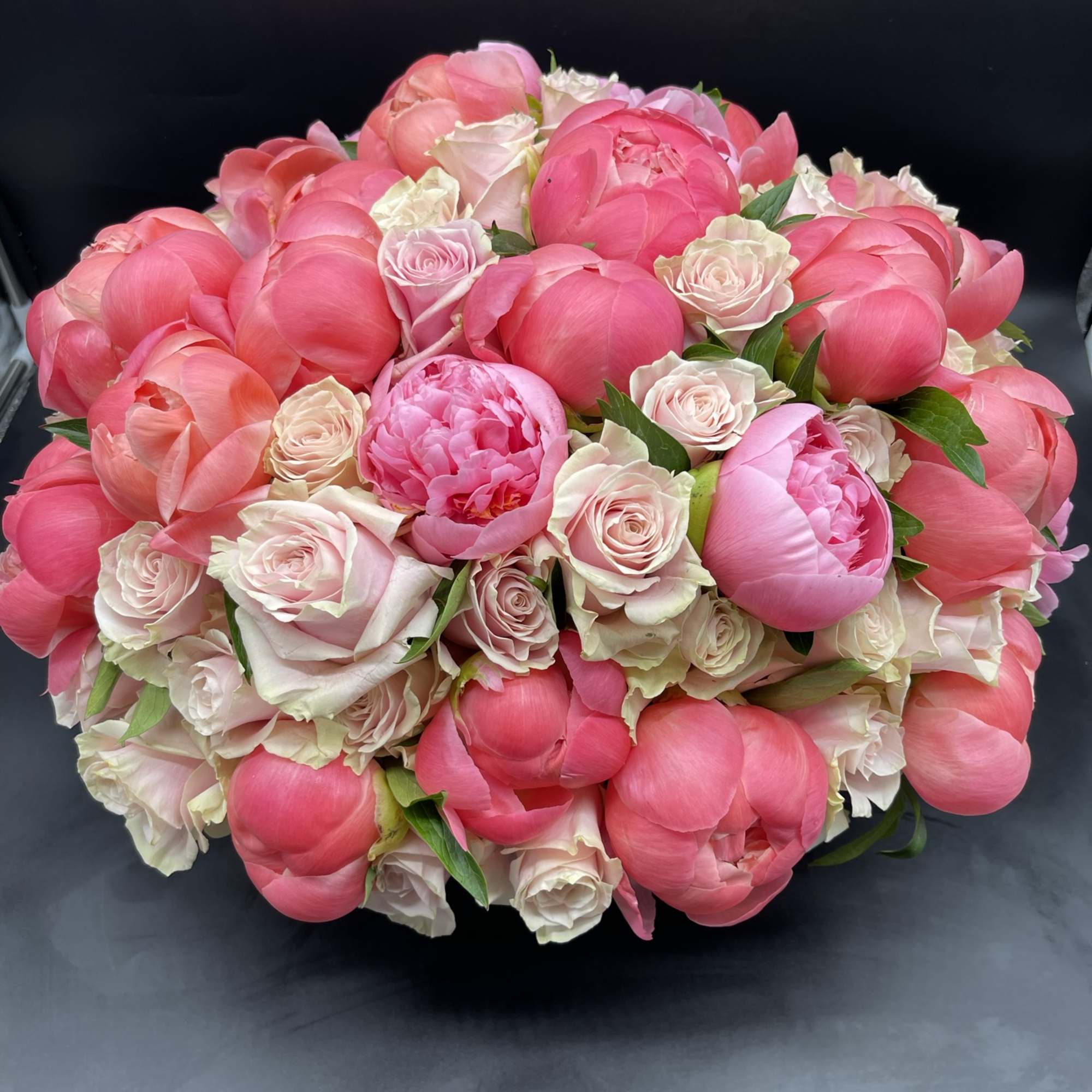 30 pink peonies surrounded by 50 stunning roses in a a white