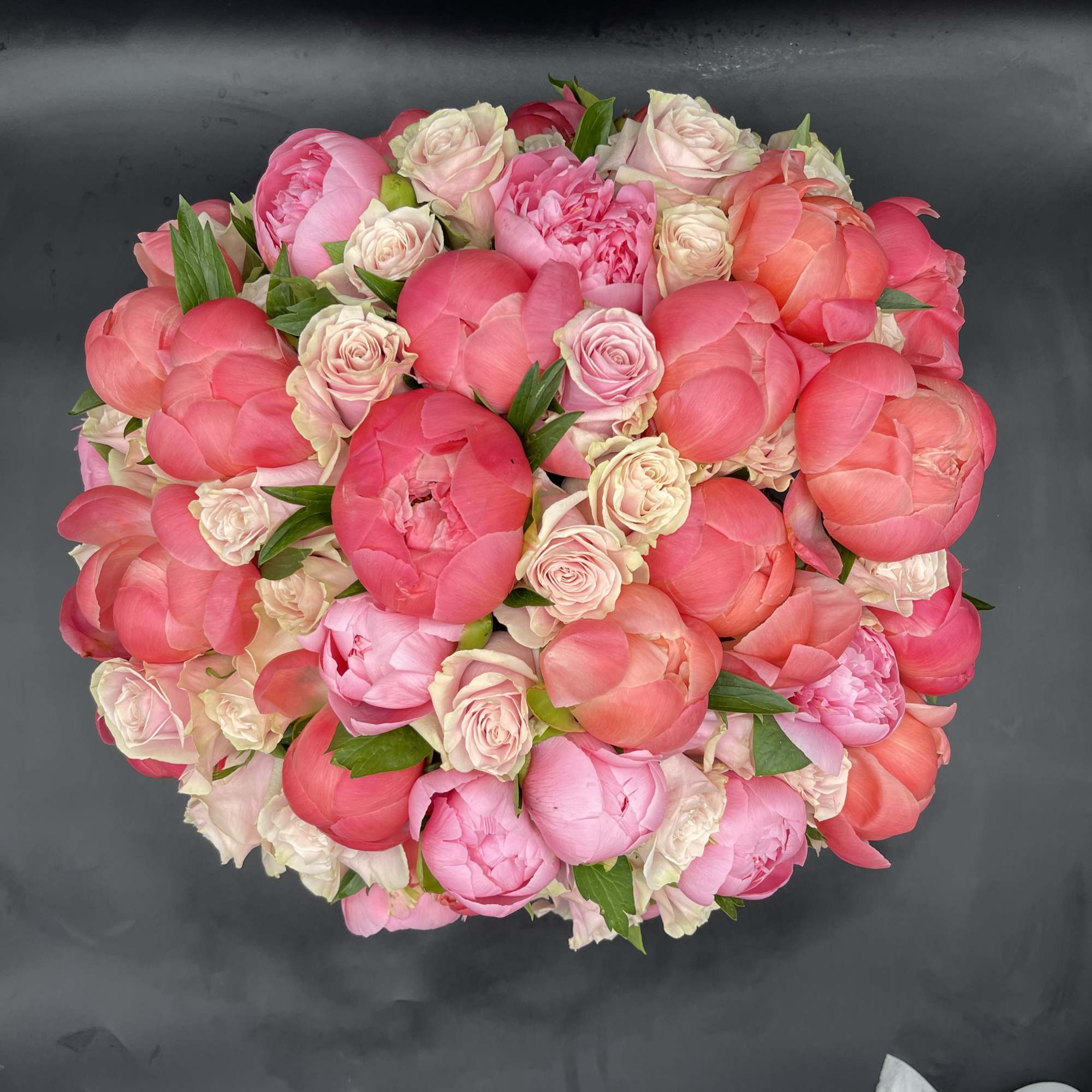 30 pink peonies surrounded by 50 stunning roses in a a white