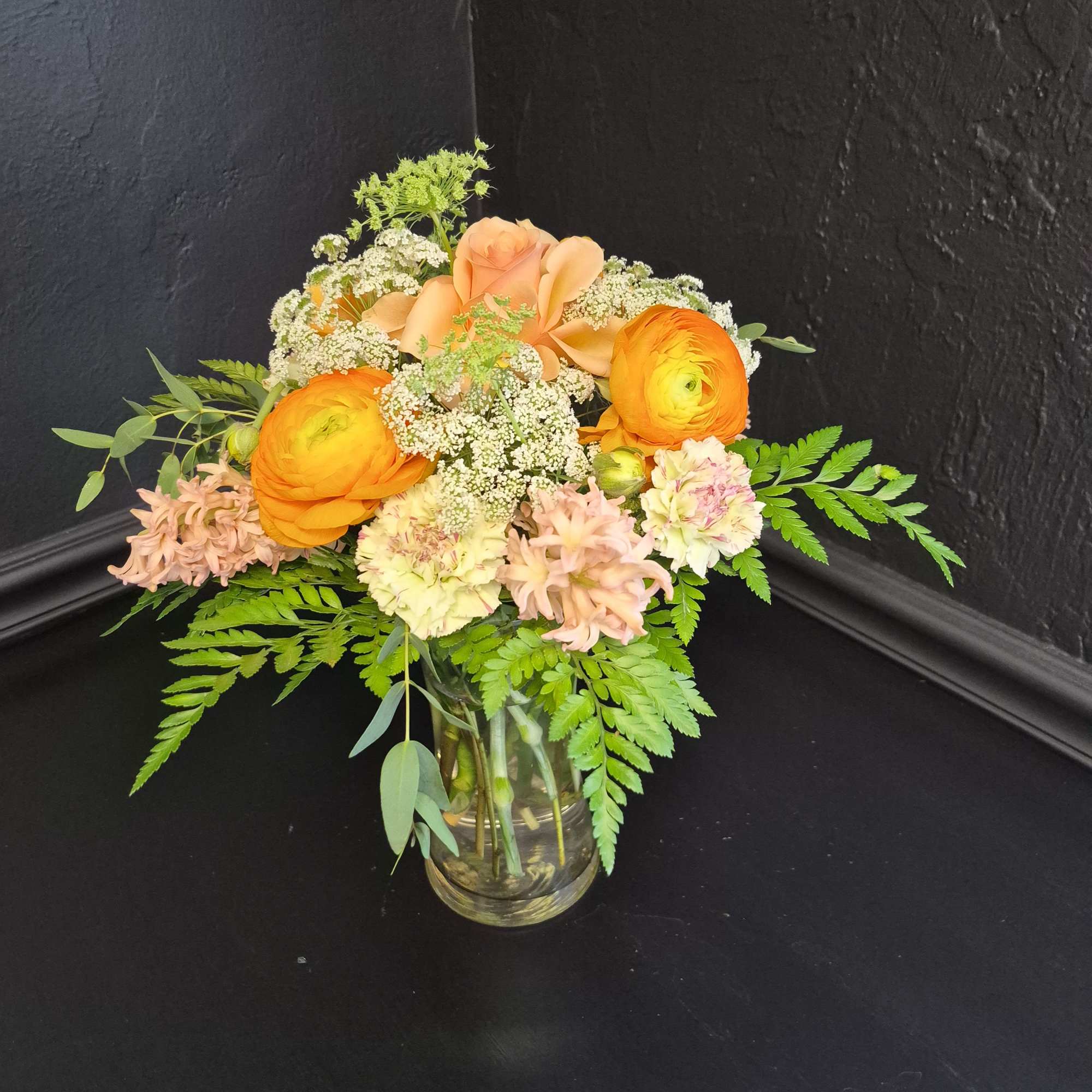 Bright orange ranunculus take center stage in this cheerful flower arrangement, paired, photo 2 of 2