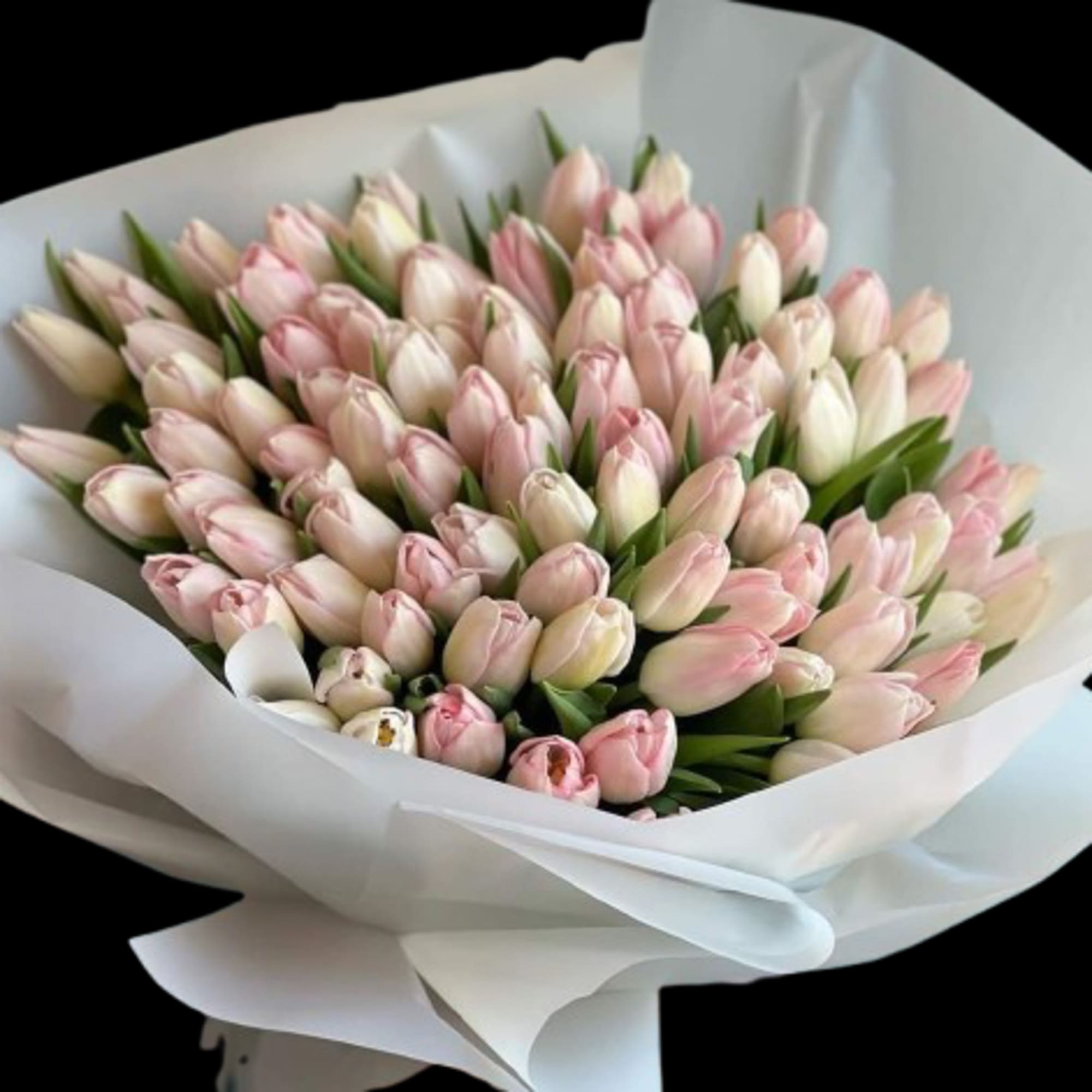 A cluster of bright pink tulips arranged in a compact, hand-tied bouquet