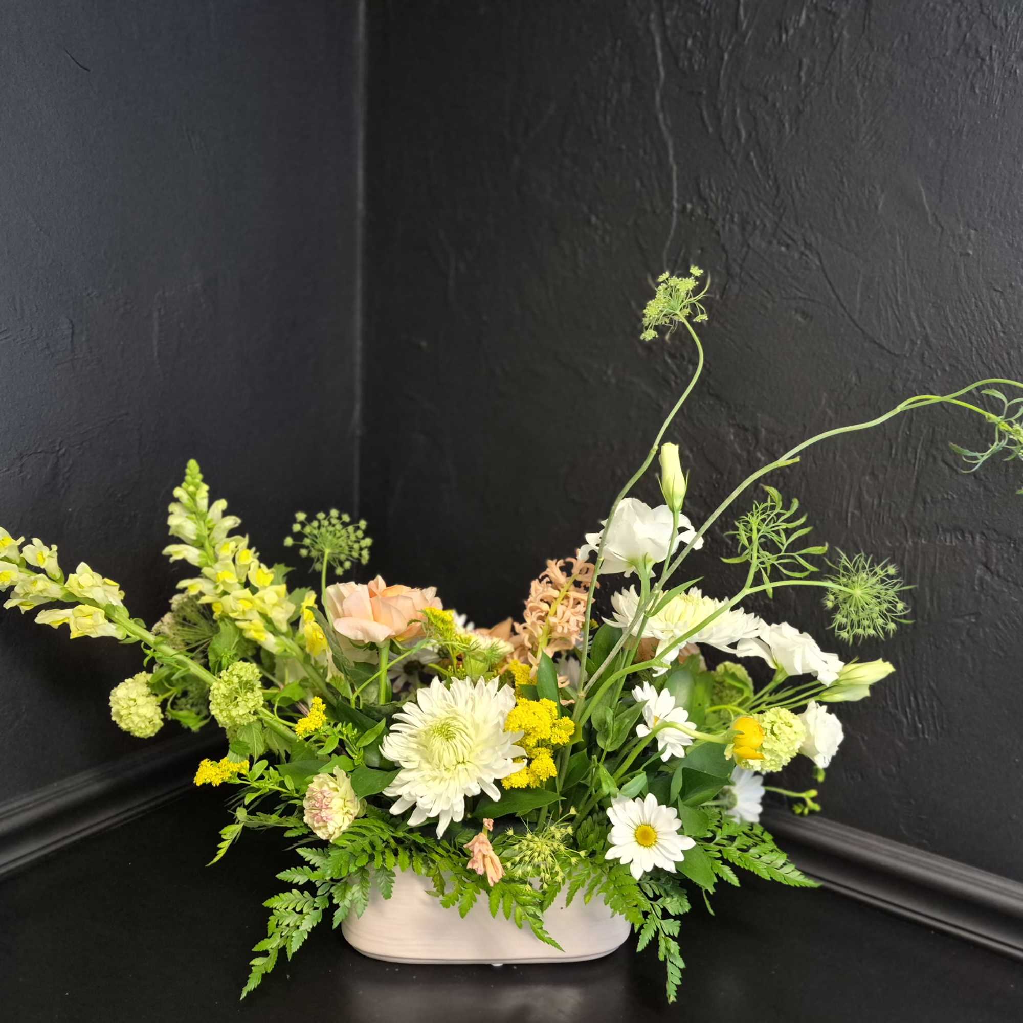 Peach garden roses and airy snapdragons spill from a low white ceramic, photo 2 of 2