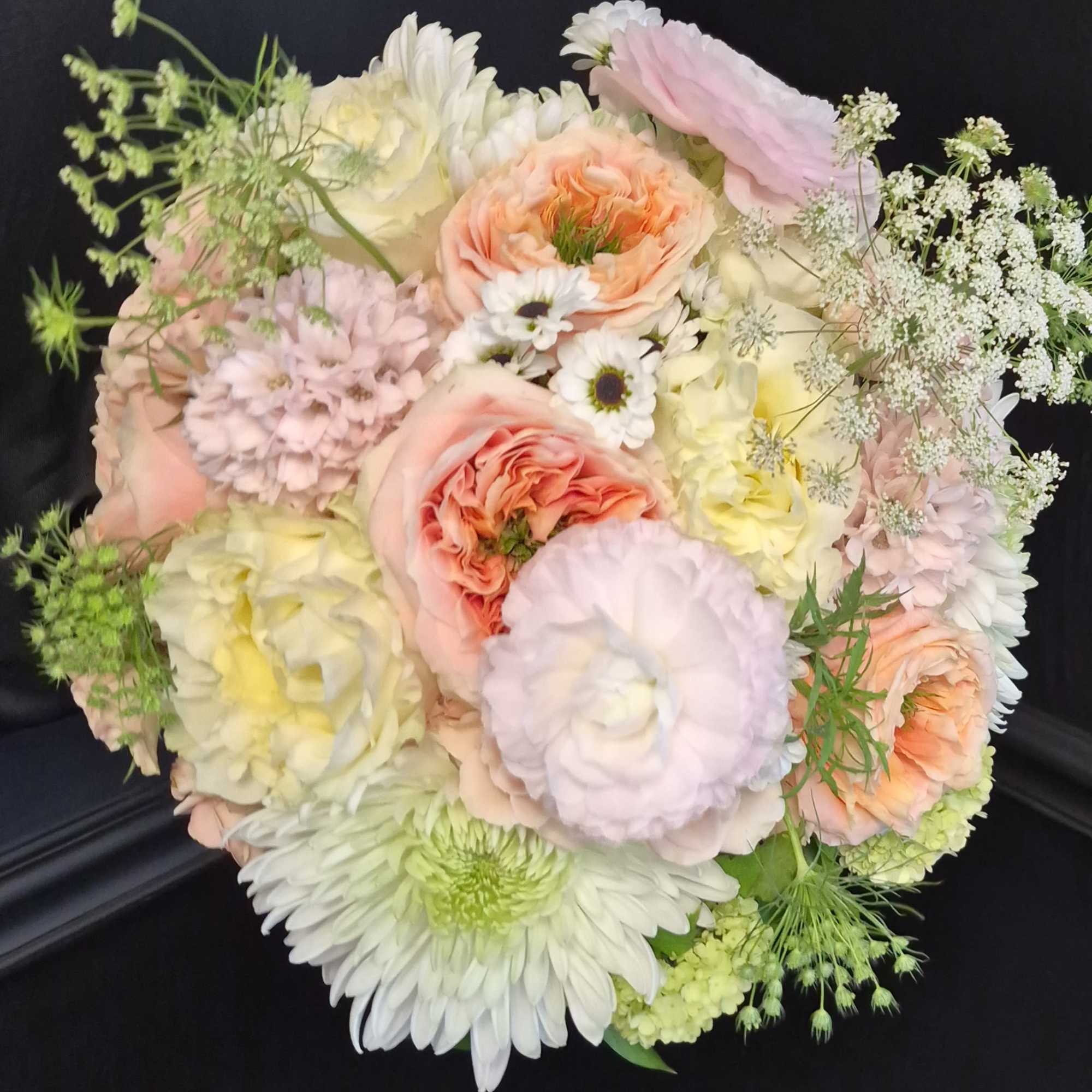 Soft blush roses and creamy peach blooms mingle with pale yellow daisies, photo 2 of 2