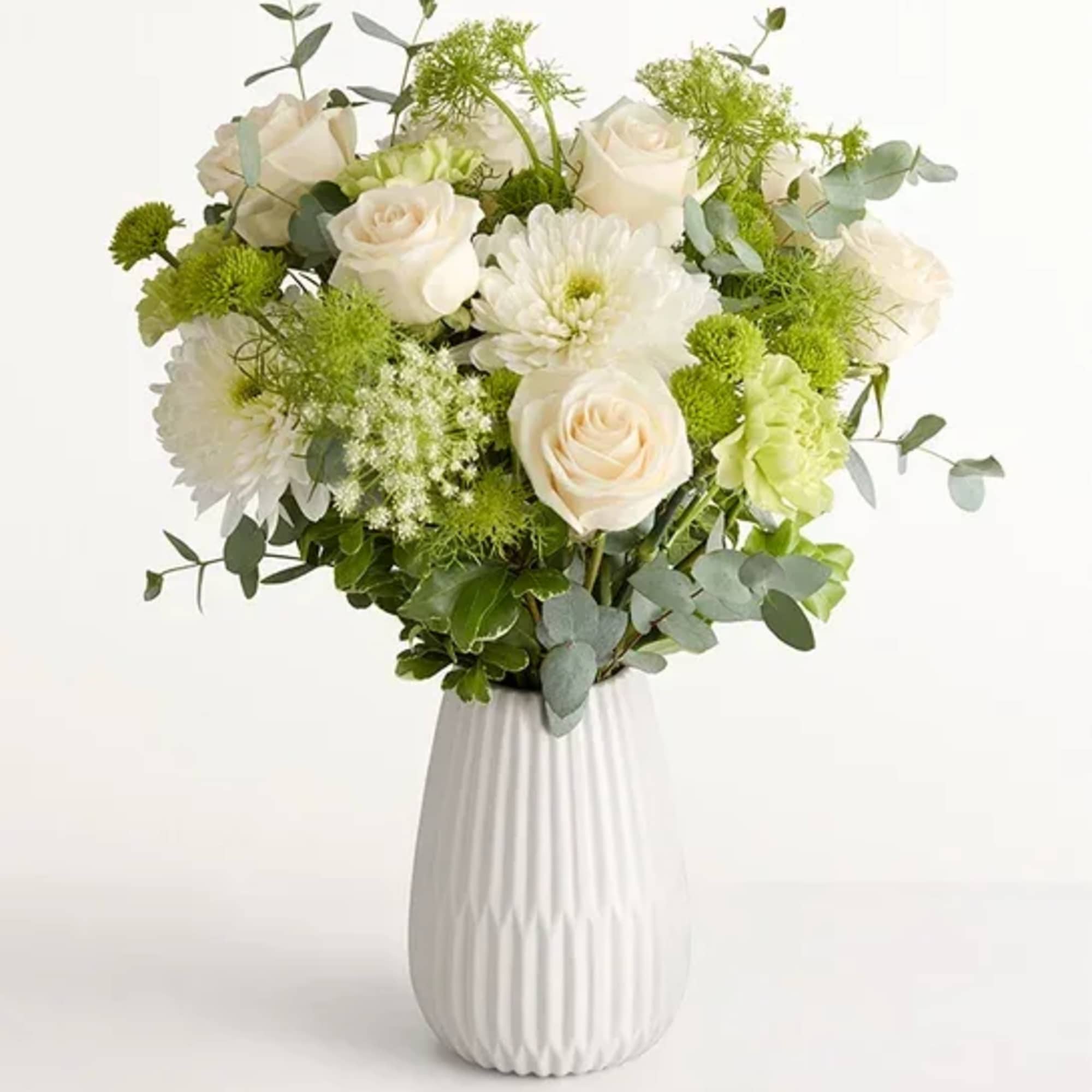 Soft white roses and full chrysanthemum blooms mingle with pale green button