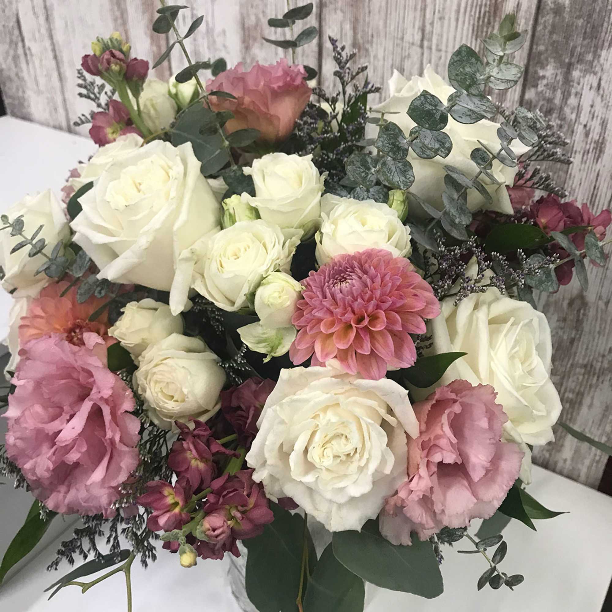 Bouquet of white and pink roses with a pink dahlia