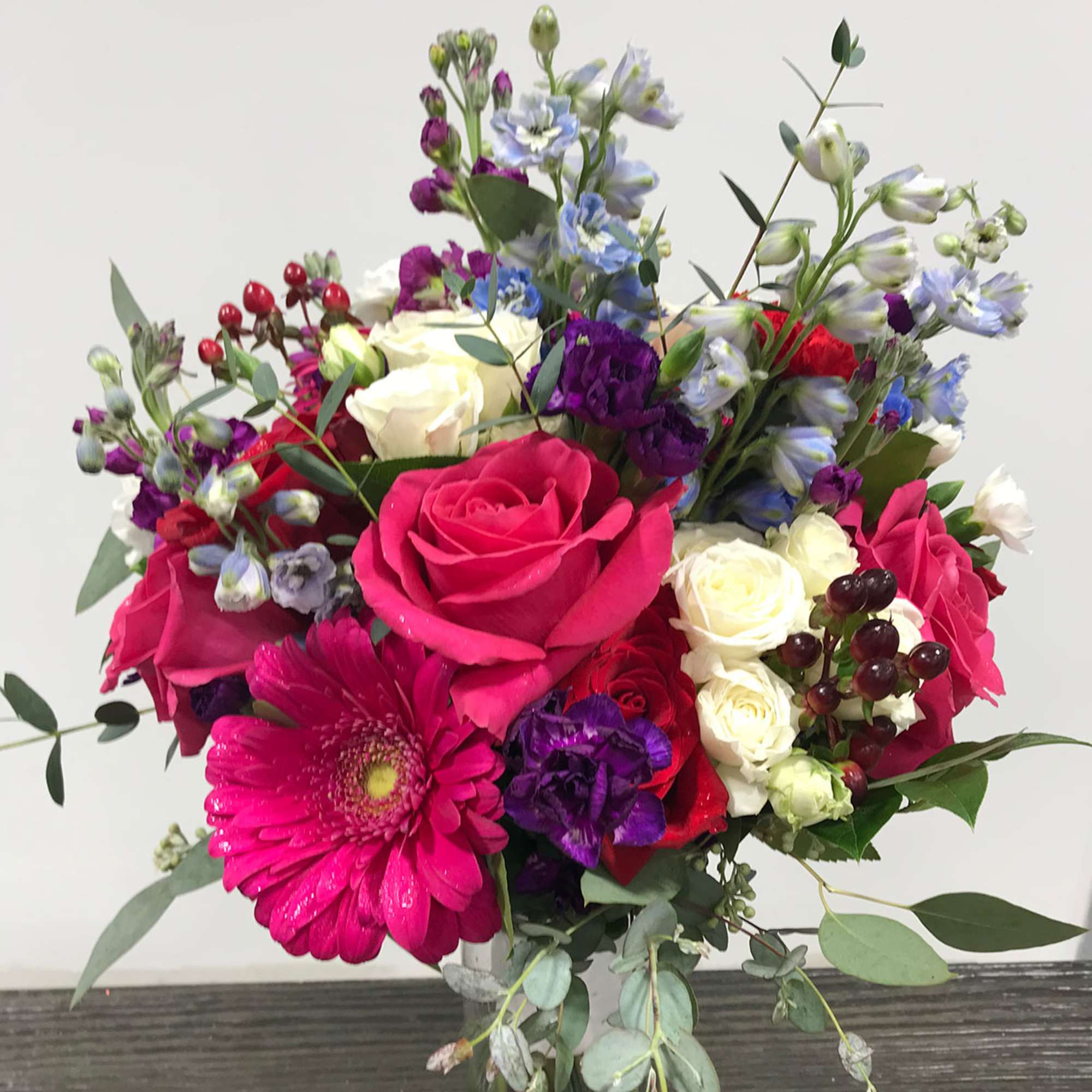 Mixed bouquet of pink, white, purple, and blue flowers