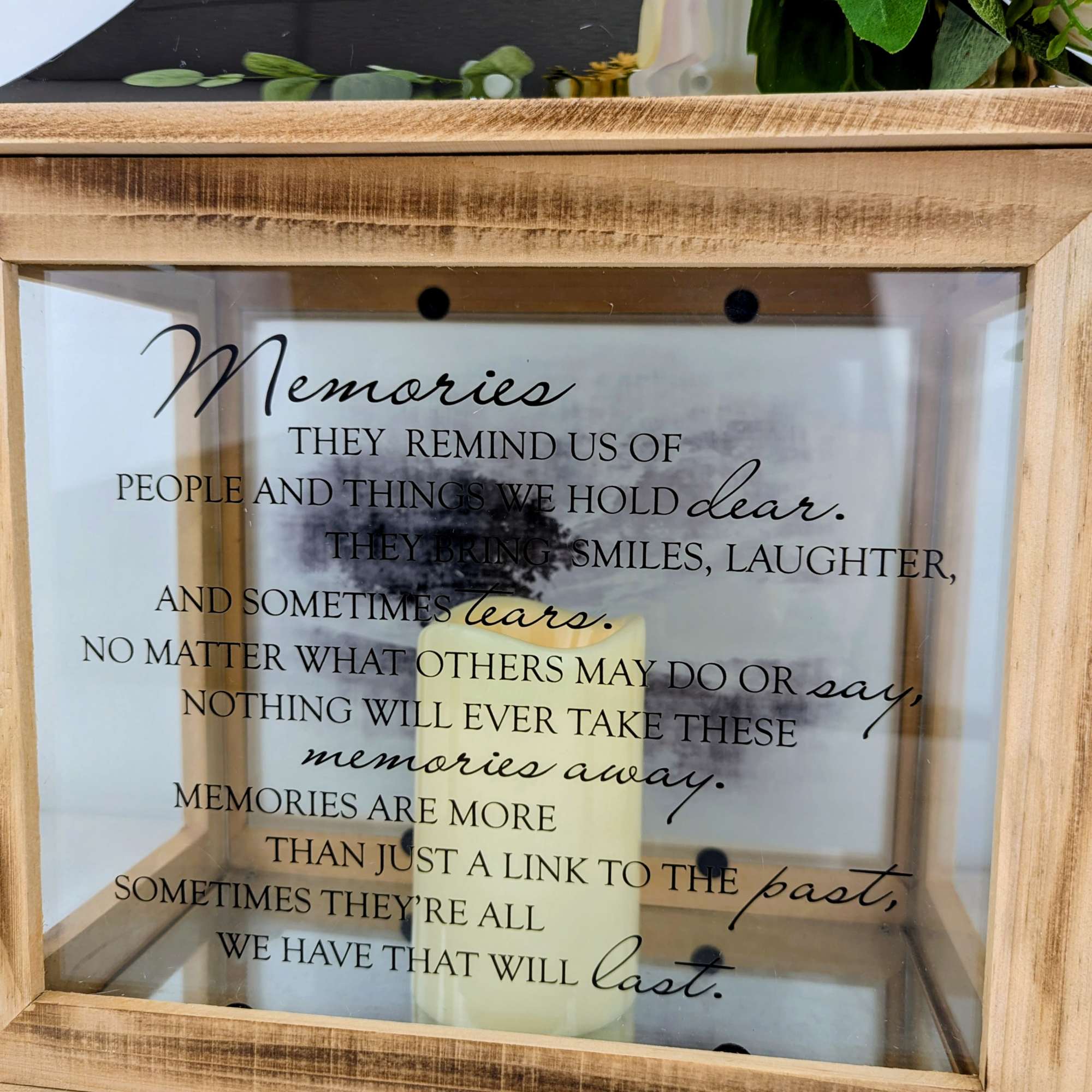 Wooden memorial lantern with a candle and remembrance quote