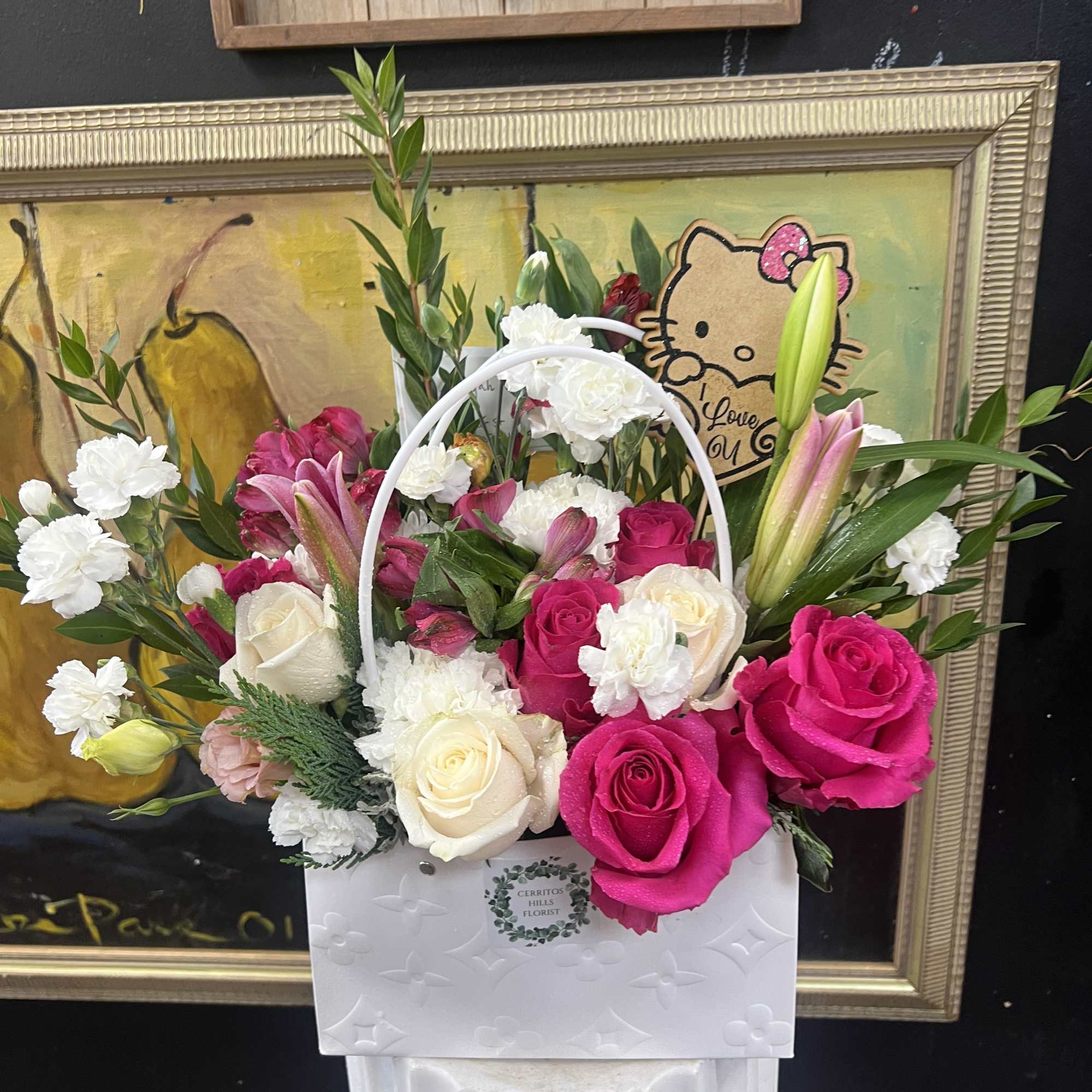 Pink and white roses with lilies in a white handled gift box