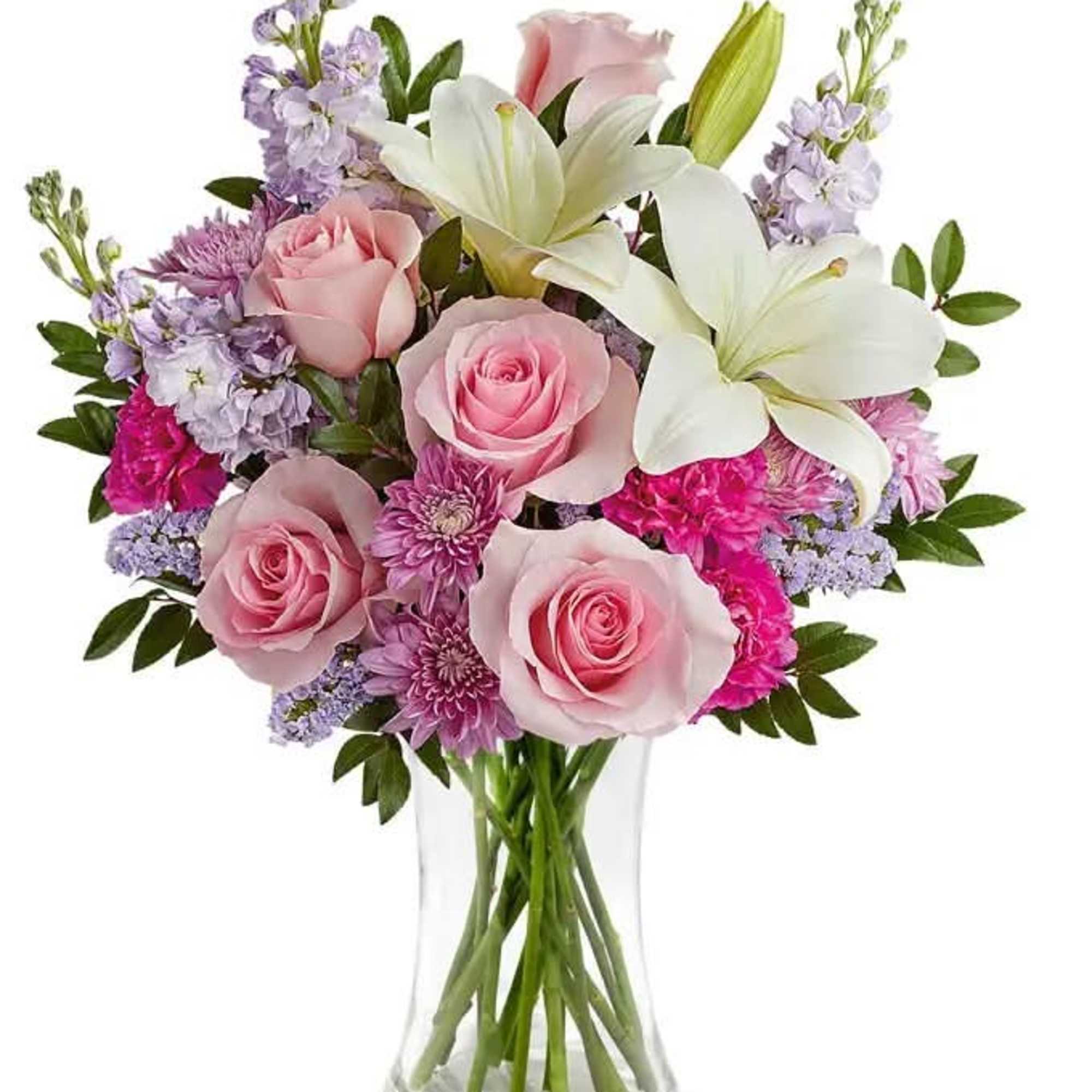 Pink roses and white lilies in a clear glass vase