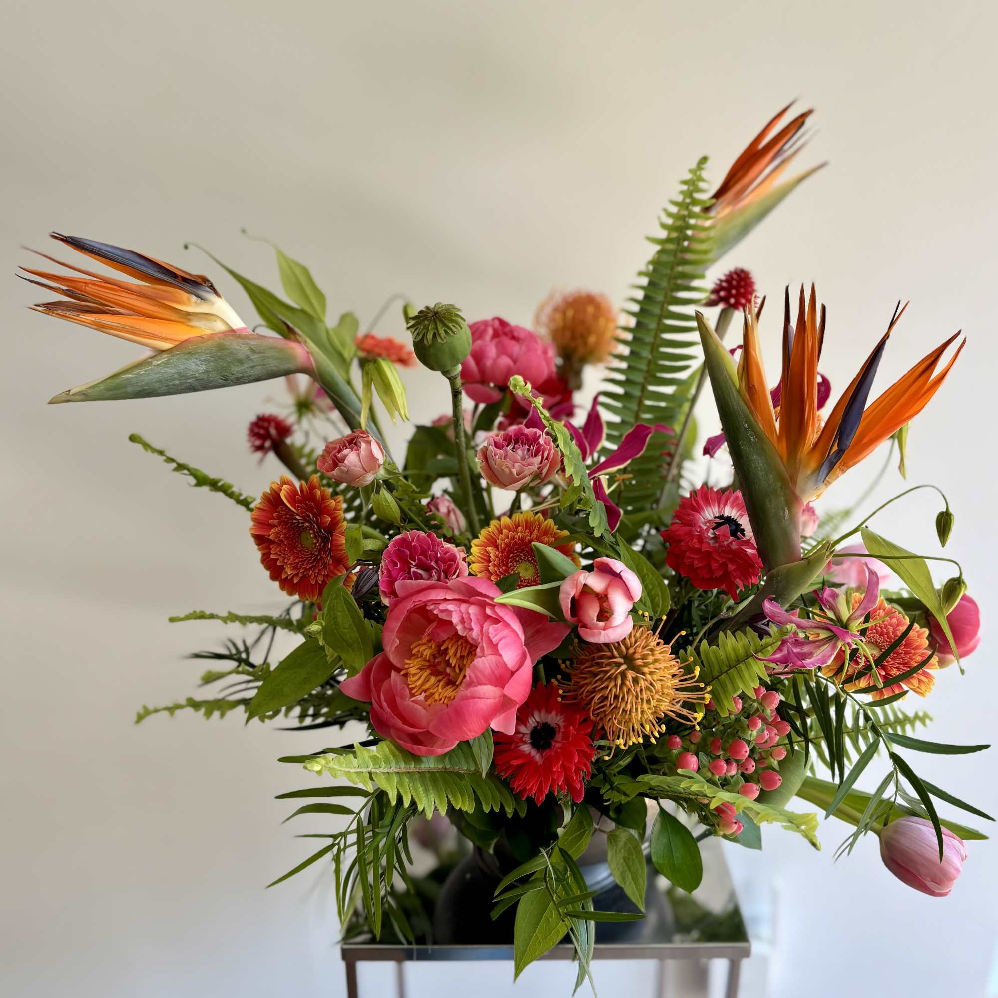 Bright tropical bouquet with pink blooms and bird-of-paradise flowers