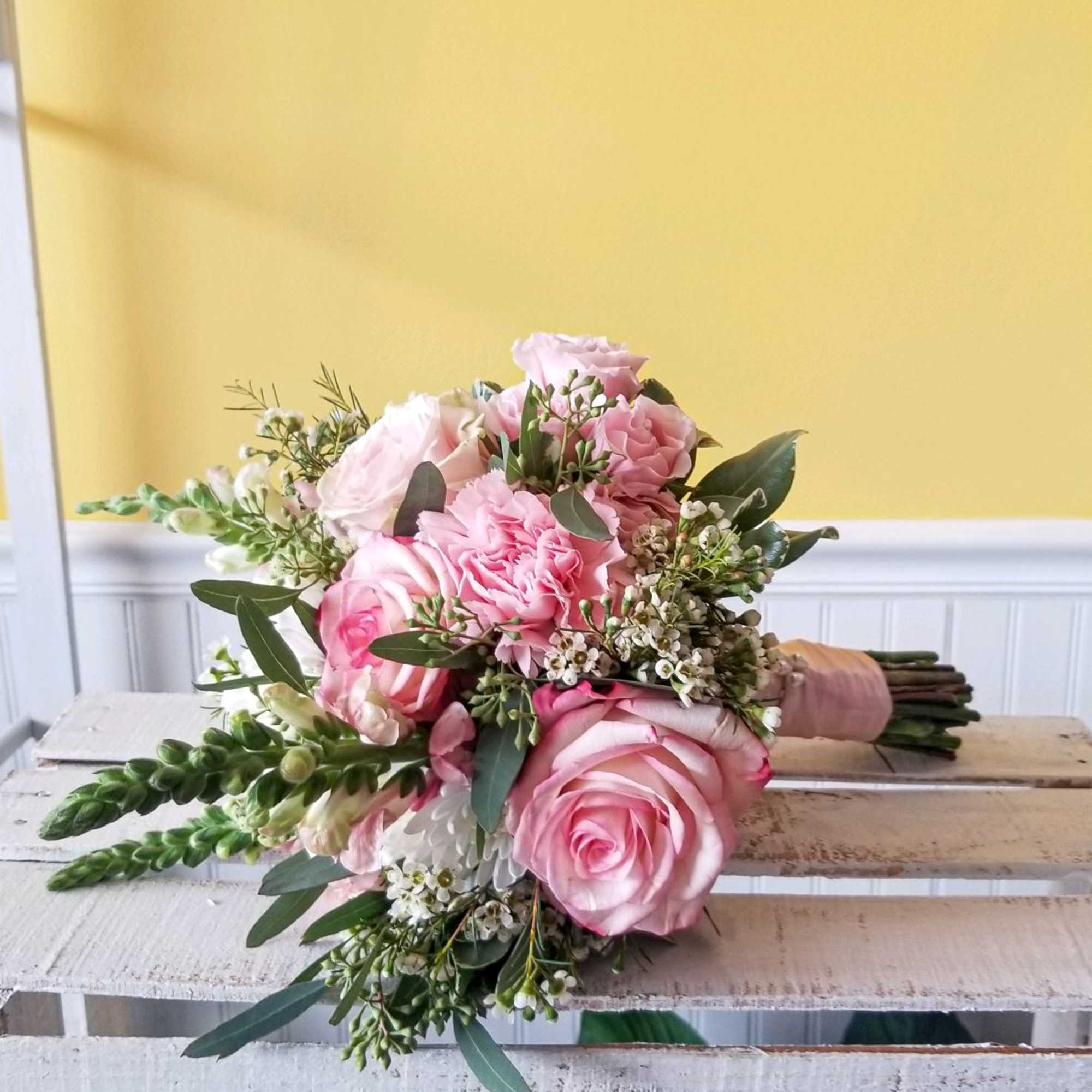 Pink rose bouquet with white filler flowers and greenery