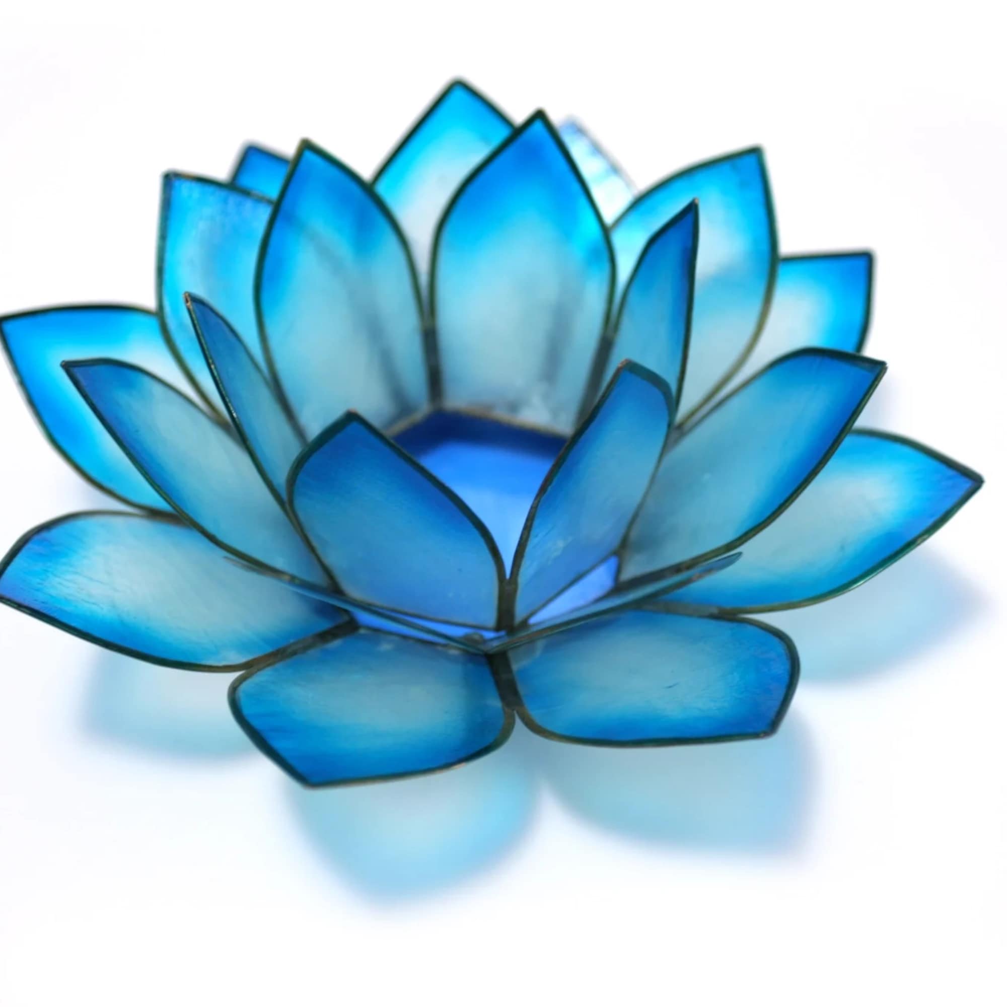 Blue lotus-shaped decorative candle holder on a white background