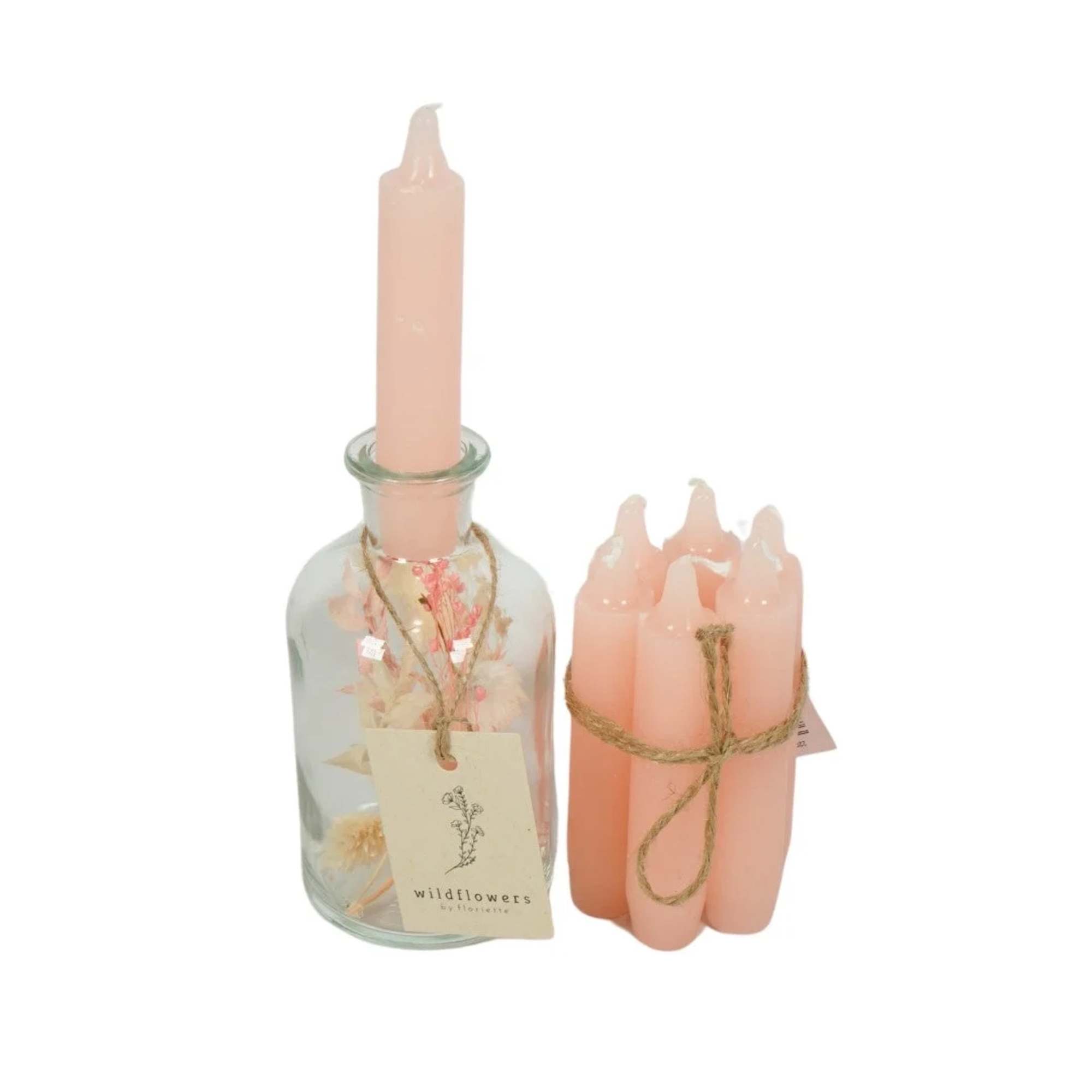 Pink candles in a glass bottle and a bundled set of pink candles
