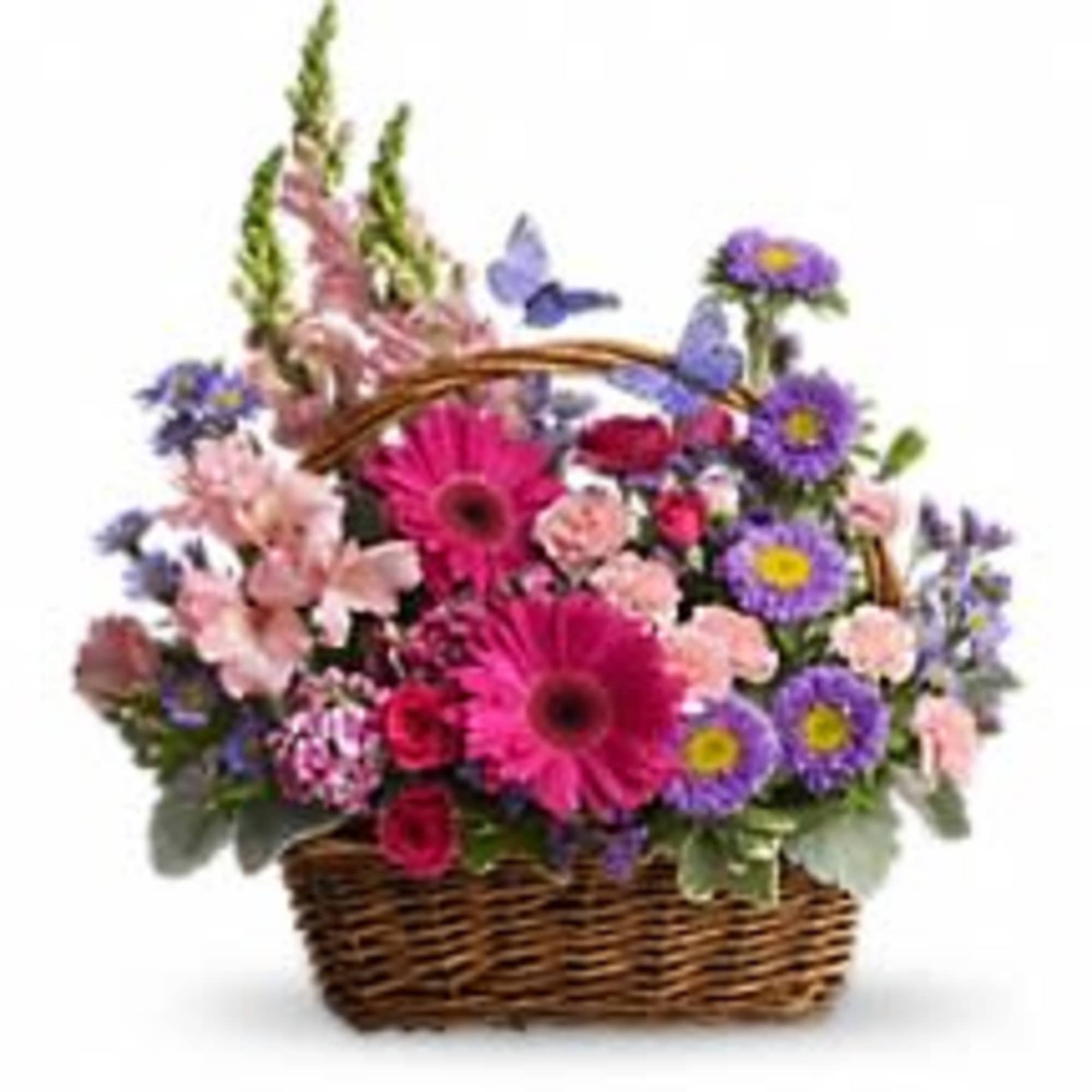 Basket of bright pink gerbera daisies, purple asters, and pastel flowers with butterflies in a woven basket.
