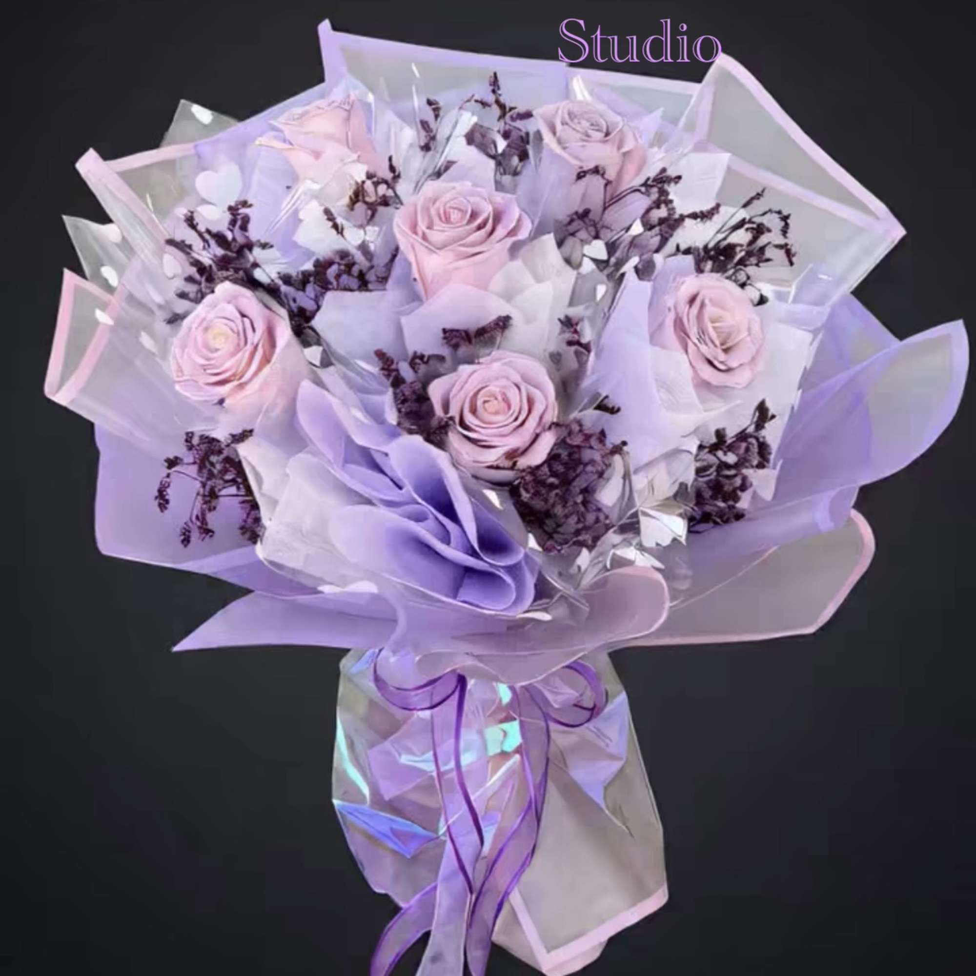Bouquet of pale pink roses wrapped in lavender paper