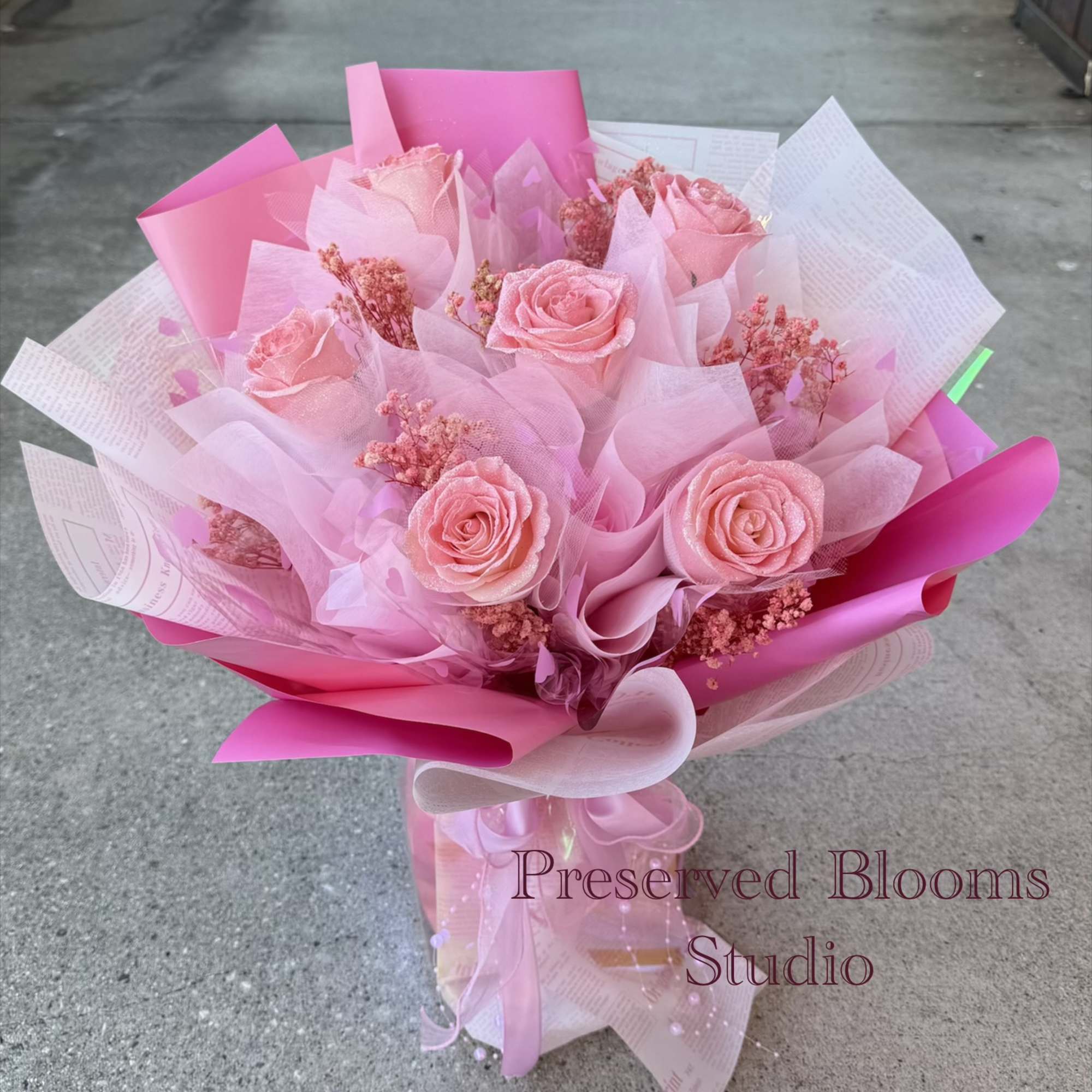 Pink rose bouquet wrapped in layered pink and white paper