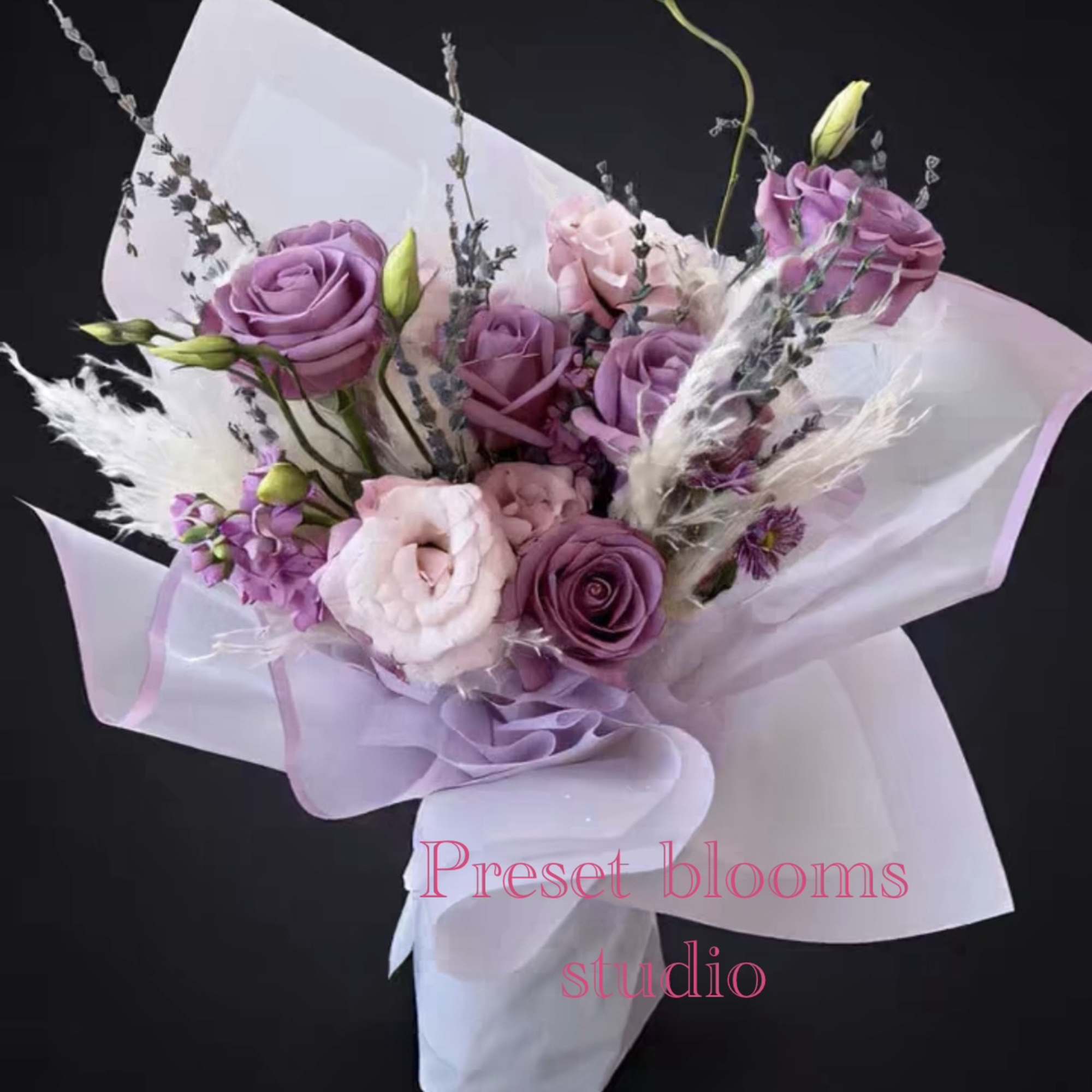 Lavender and pink rose bouquet wrapped in white paper