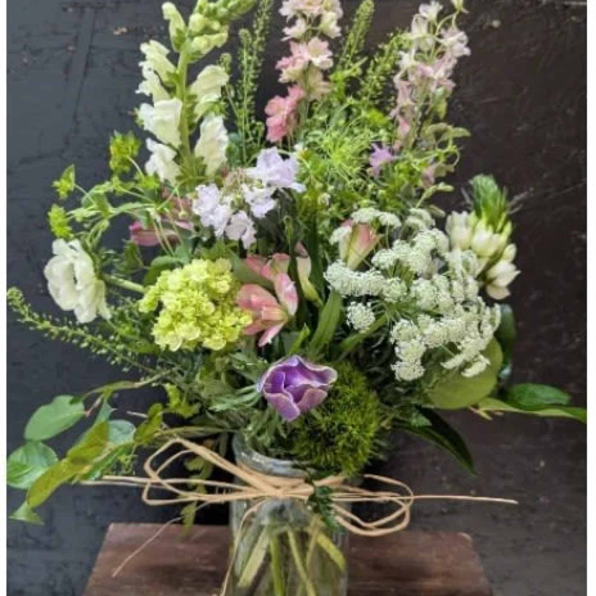 A tall, airy garden-style flower arrangement designed to feel hand-picked and fresh