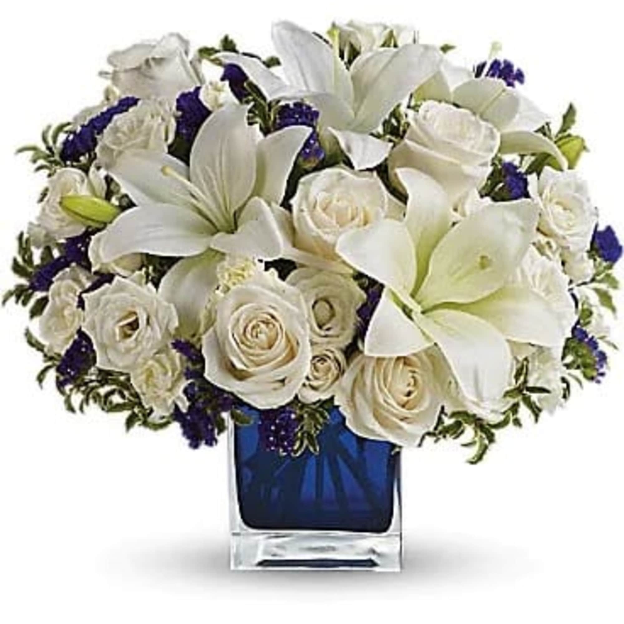 White lilies and roses in a blue glass vase