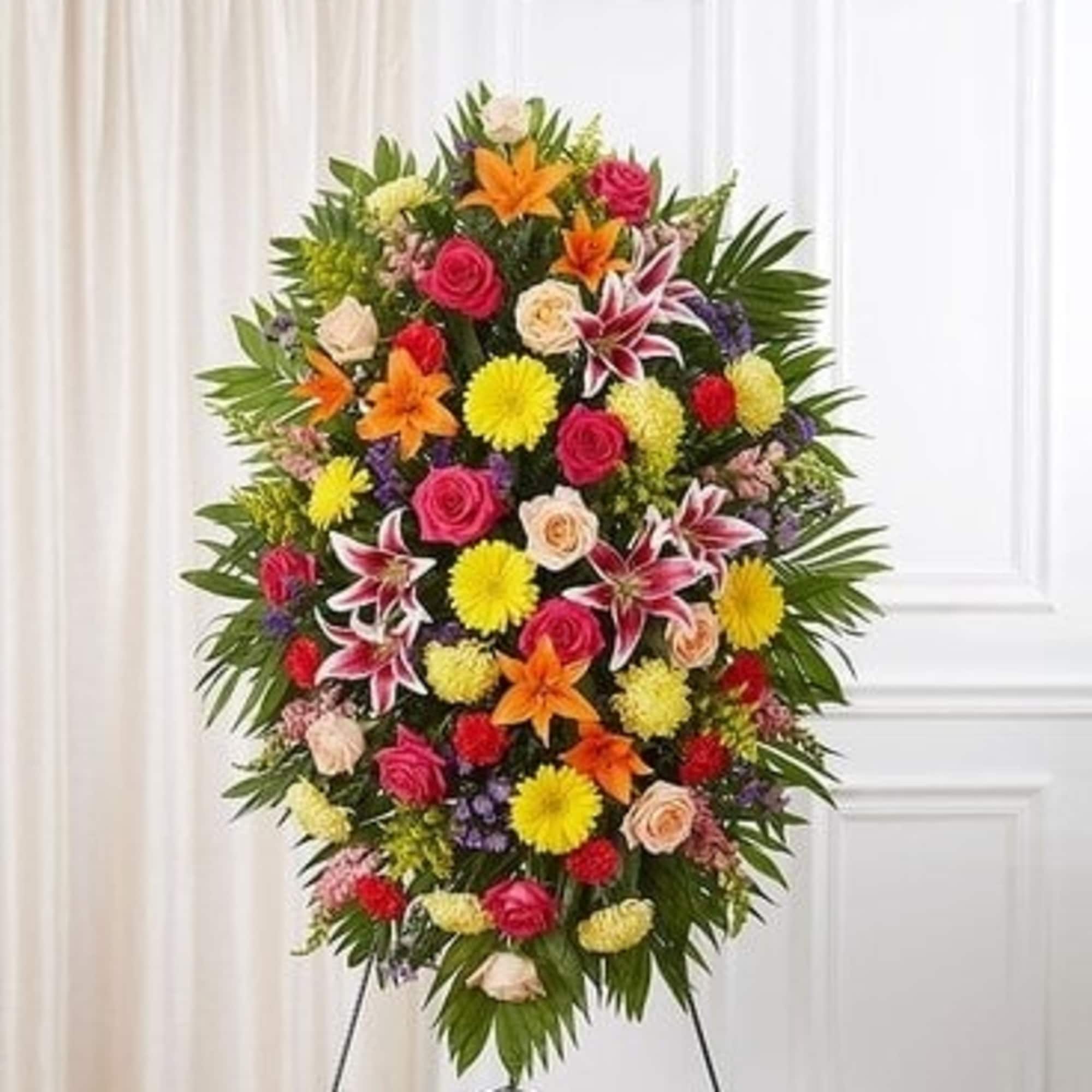 Standing spray of mixed colorful flowers on an easel