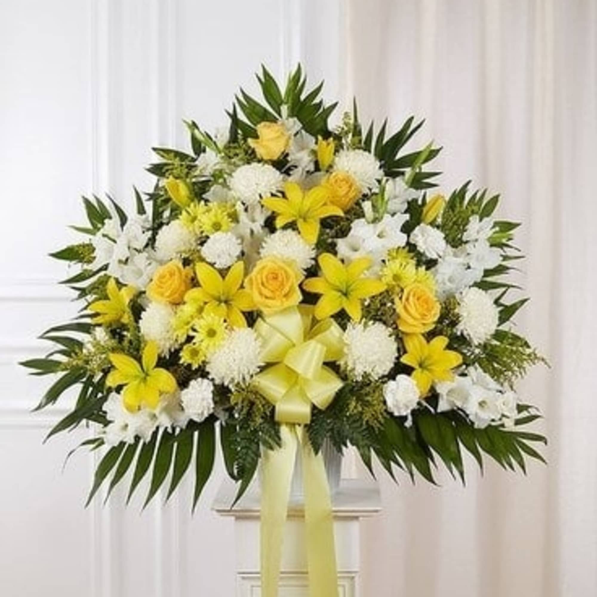 Yellow and white floral standing spray with ribbon
