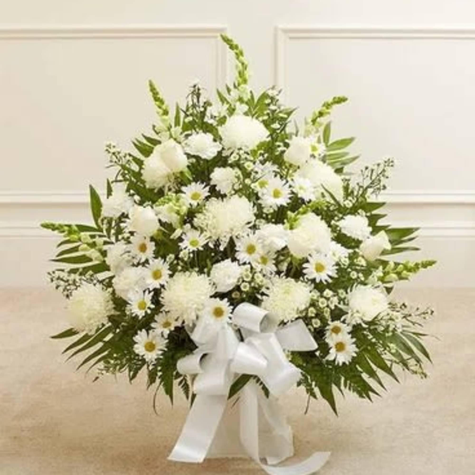 White floral standing spray with daisies and a ribbon bow