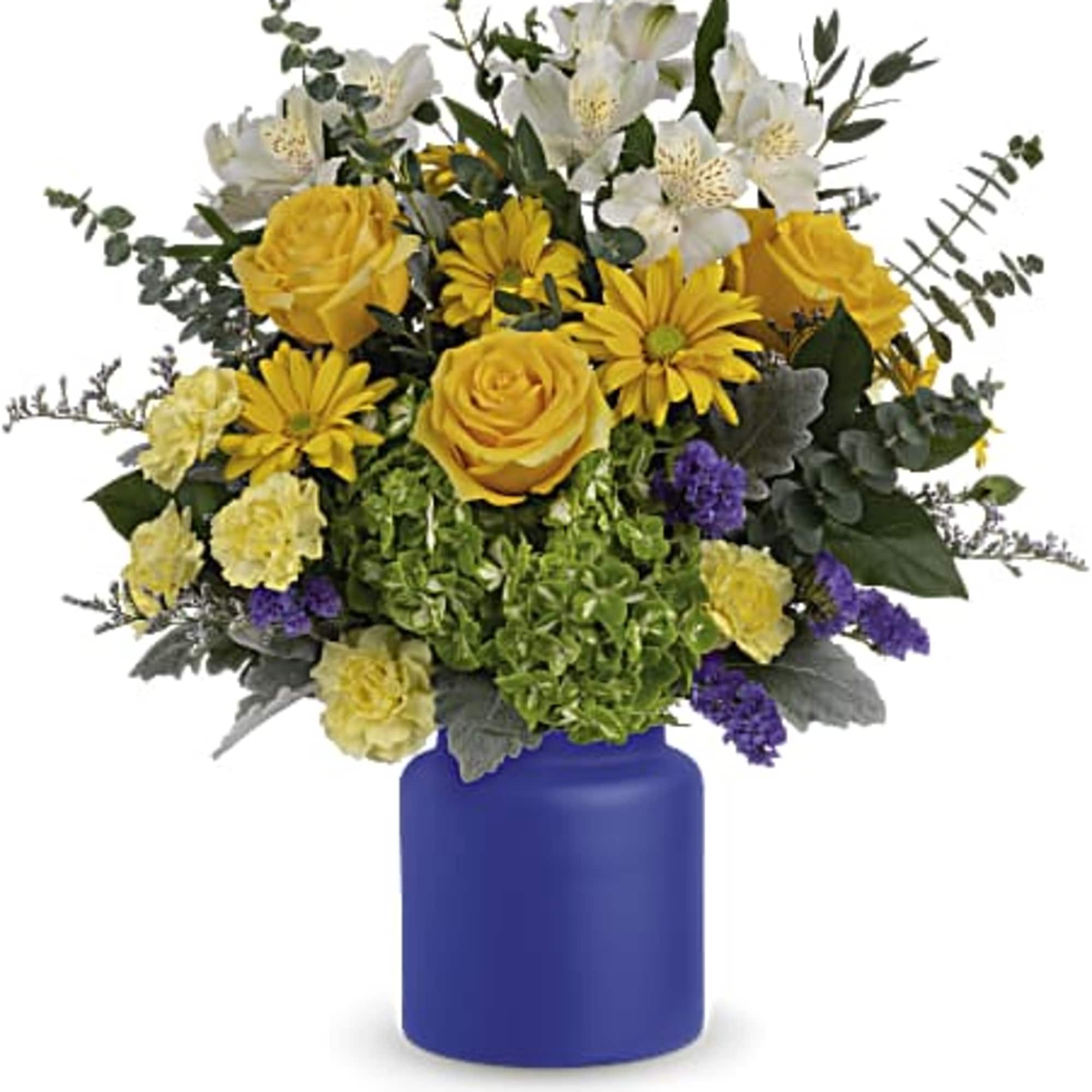 Yellow and white flower arrangement in a blue vase