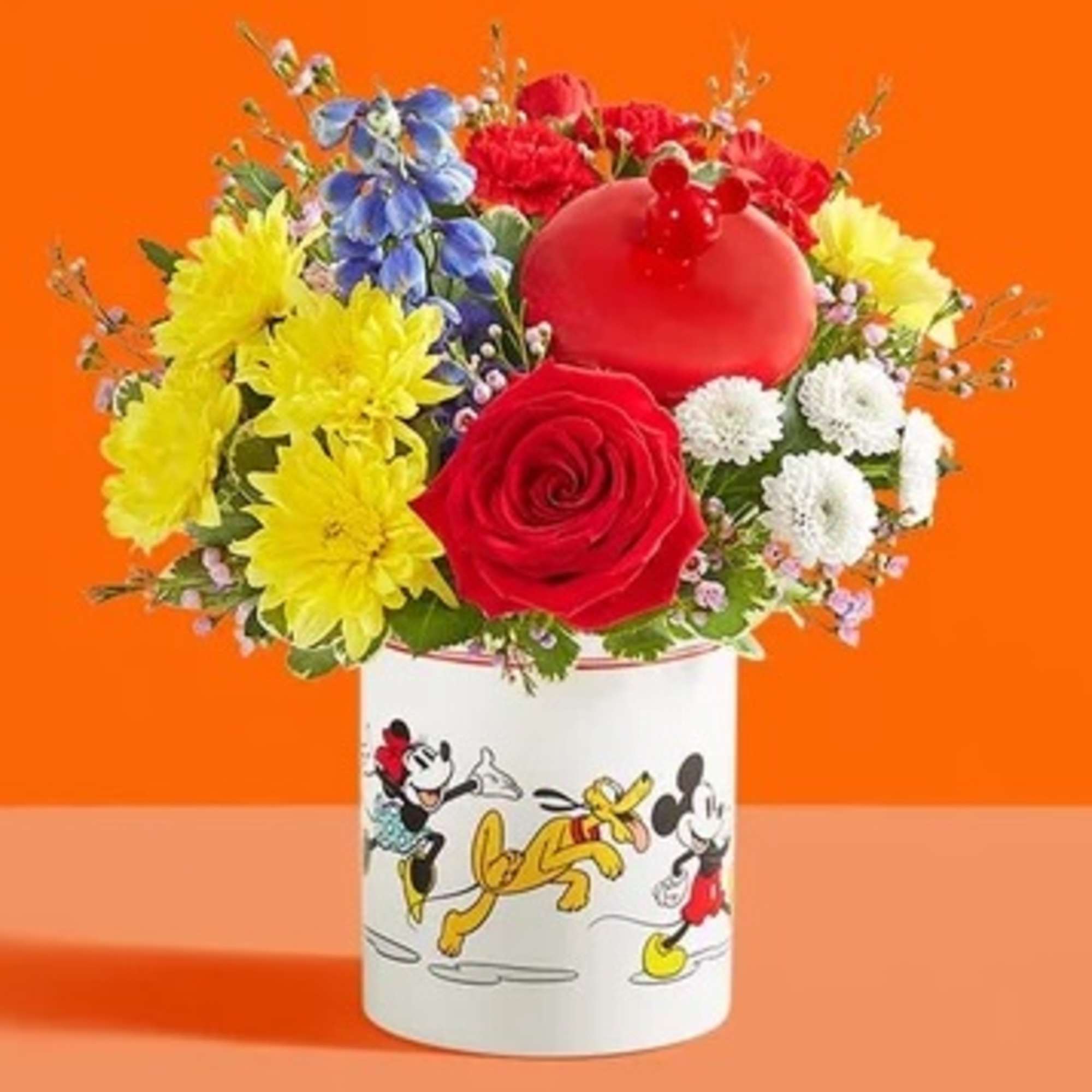 Colorful bouquet in a Mickey Mouse mug with a red balloon topper
