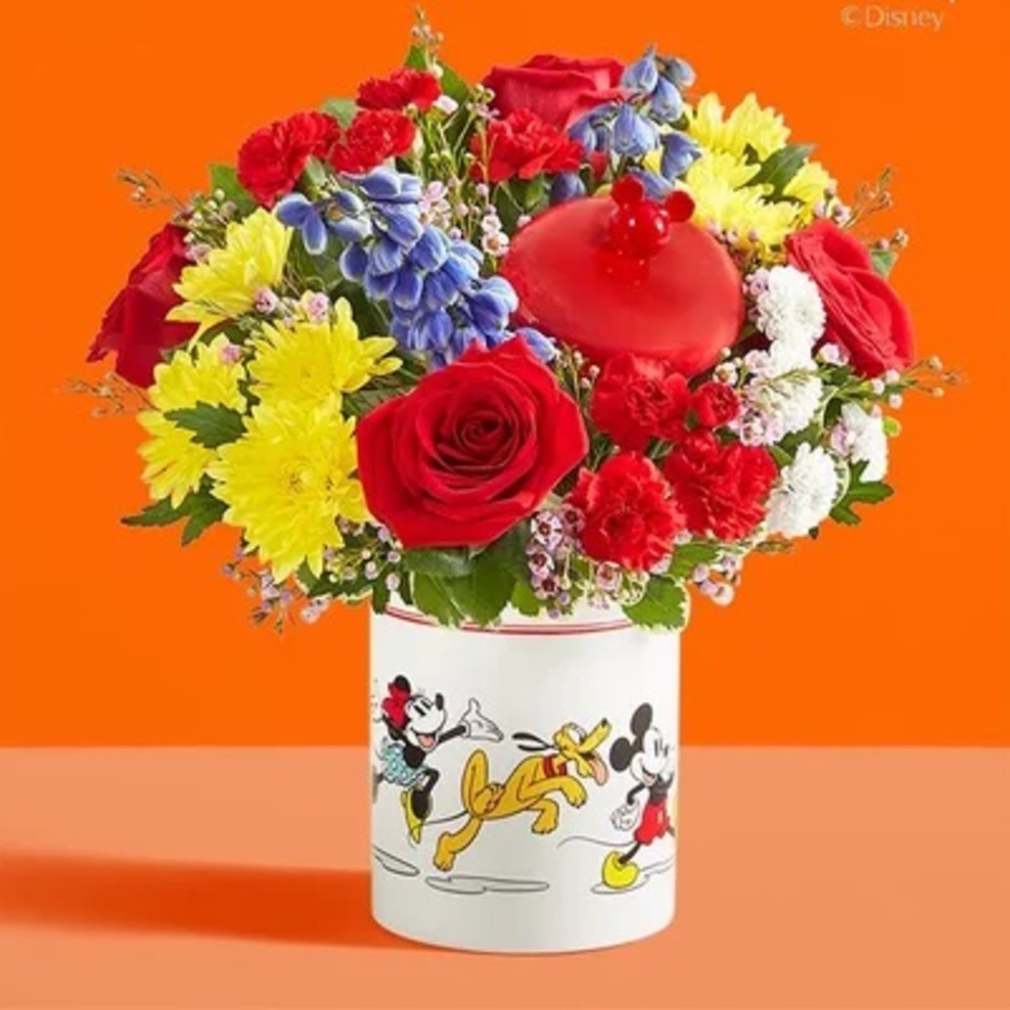 Colorful bouquet in a Mickey Mouse container with a red heart balloon