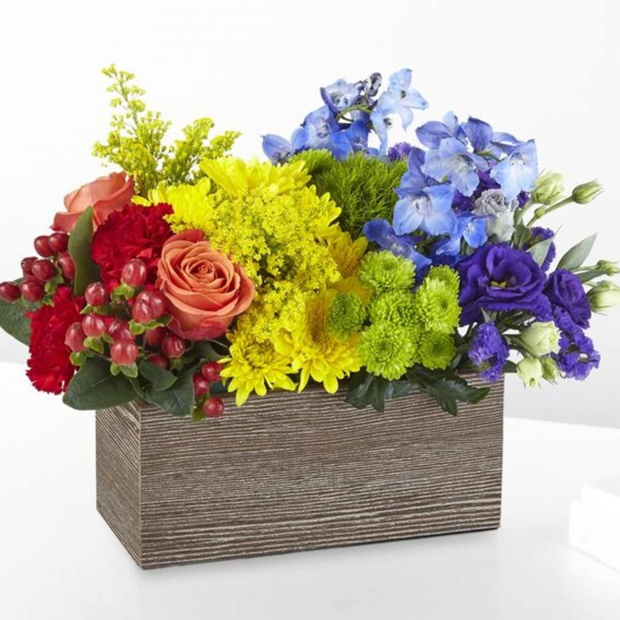Colorful mixed flower arrangement in a rectangular wooden box