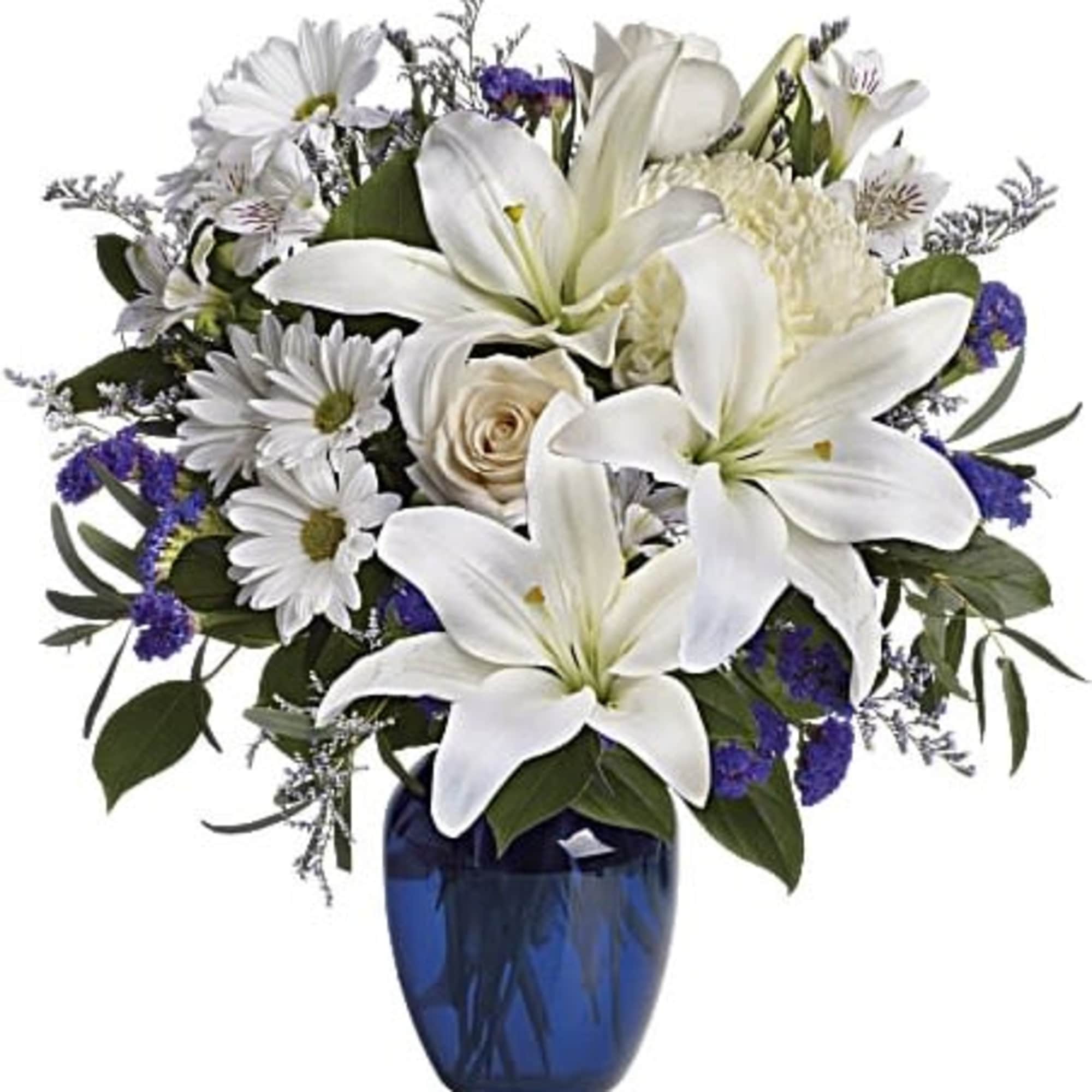 White lilies and daisies arranged in a blue vase