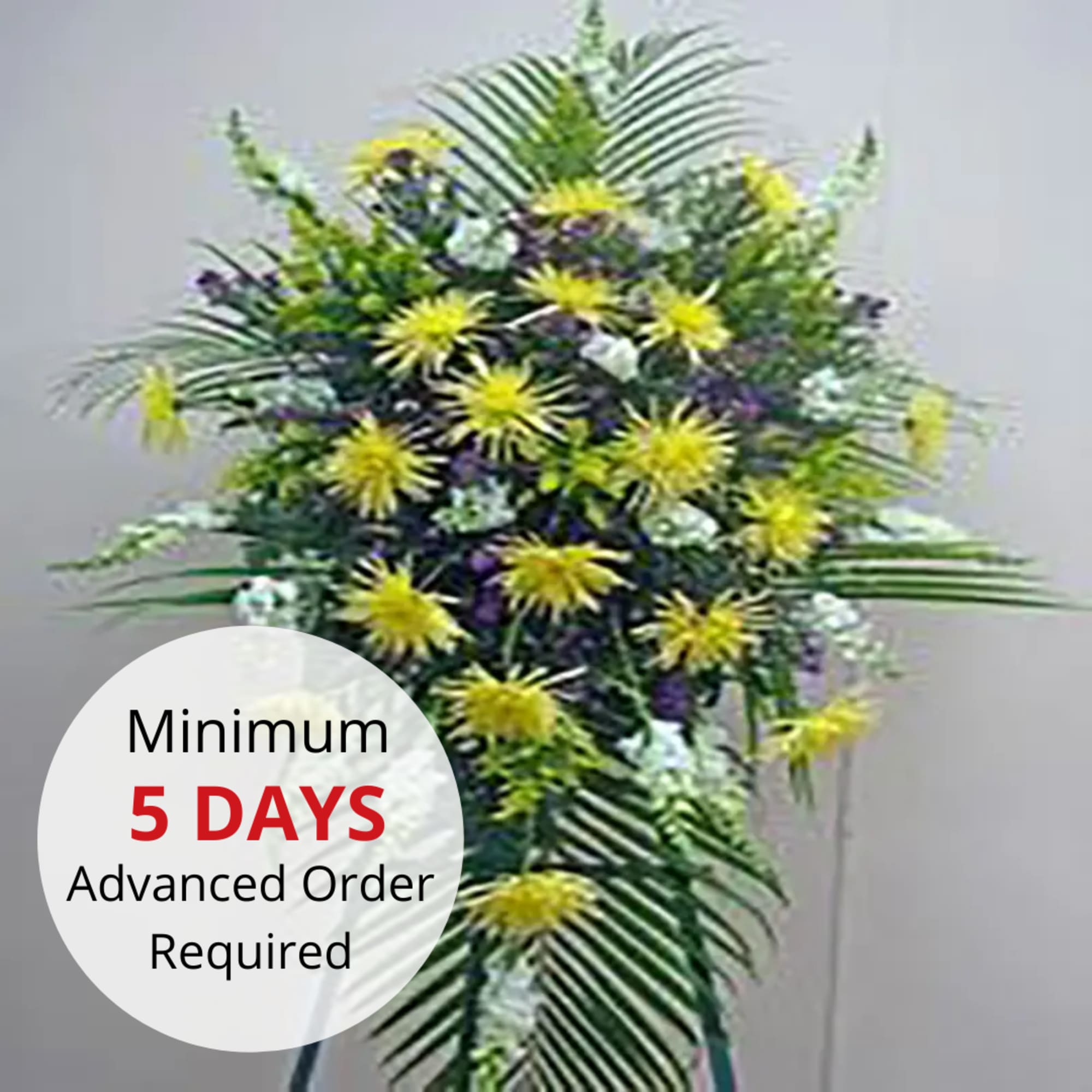 Tall standing spray with yellow chrysanthemums and white and purple flowers on an easel stand