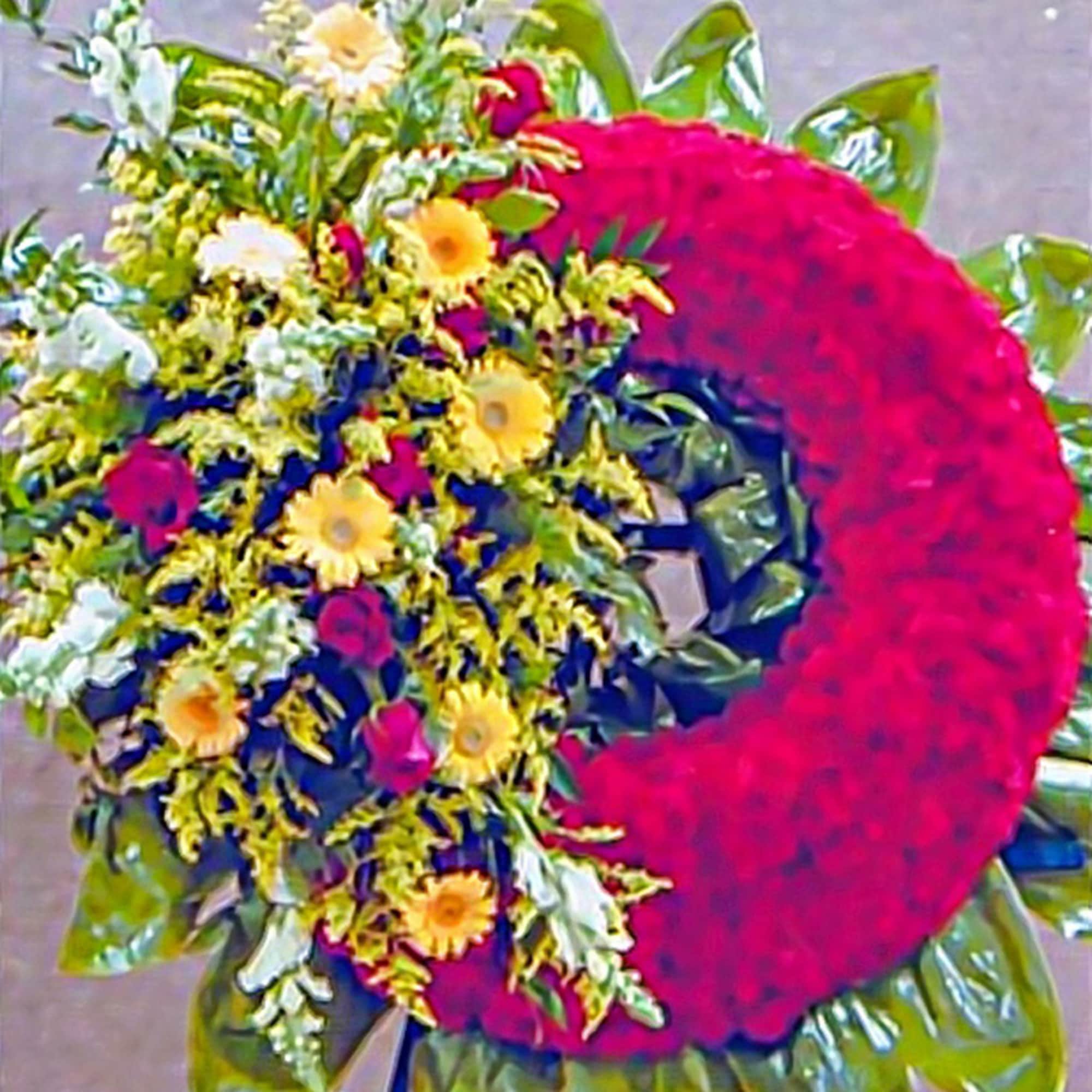 Standing red wreath with yellow and white flowers clustered on one side