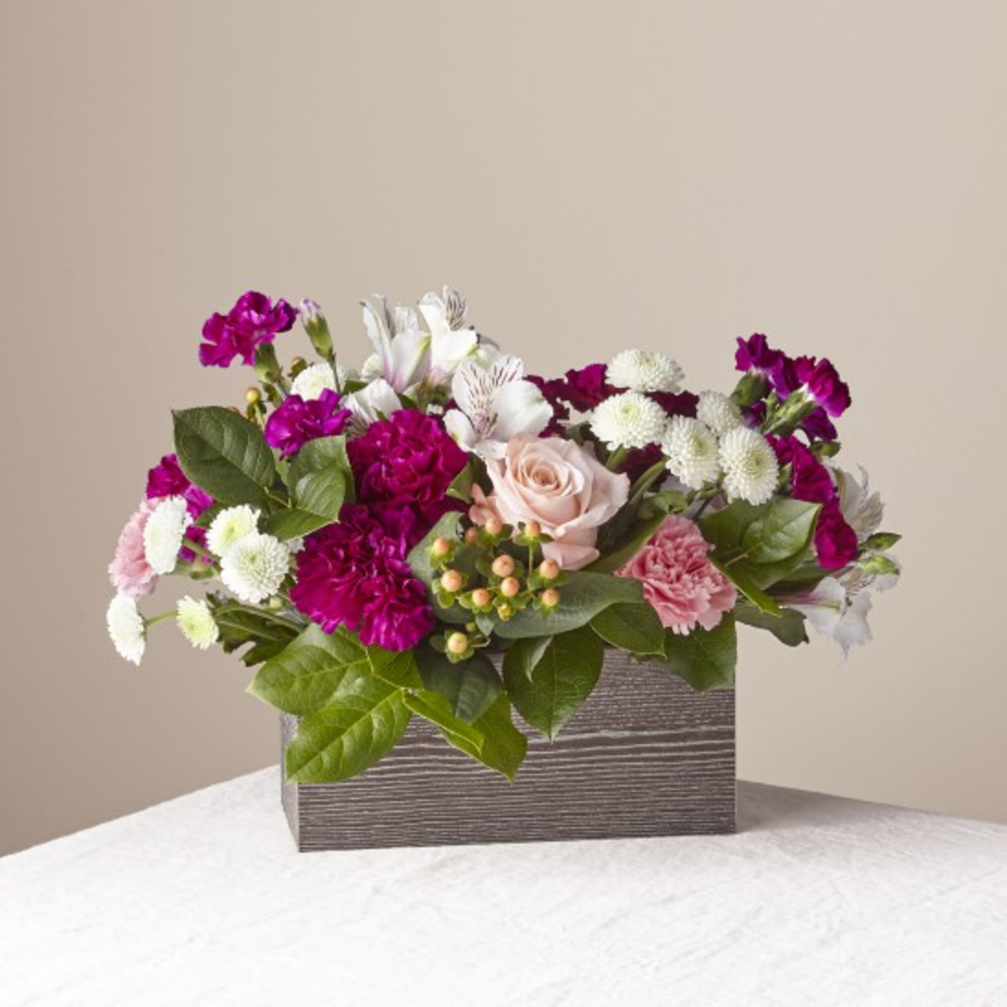 Mixed bouquet in a gray rectangular box with pink, white, and purple flowers