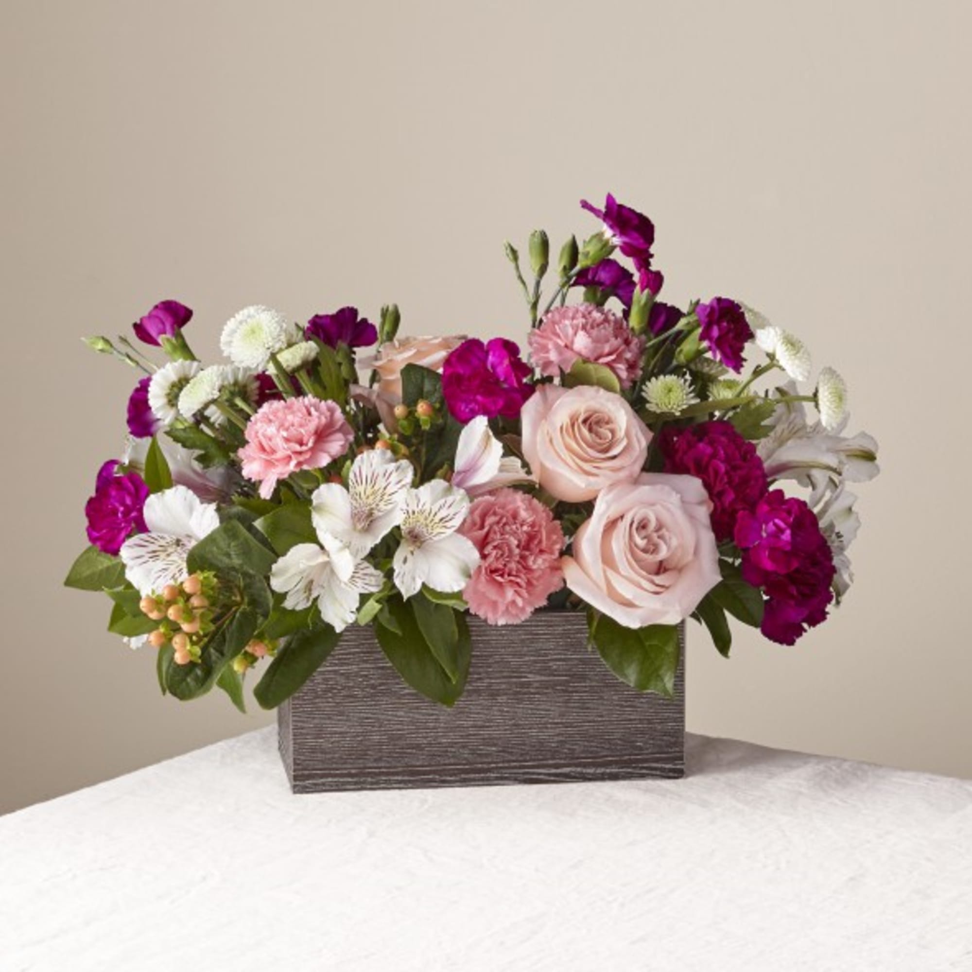 Pink and white floral arrangement in a rectangular wooden box
