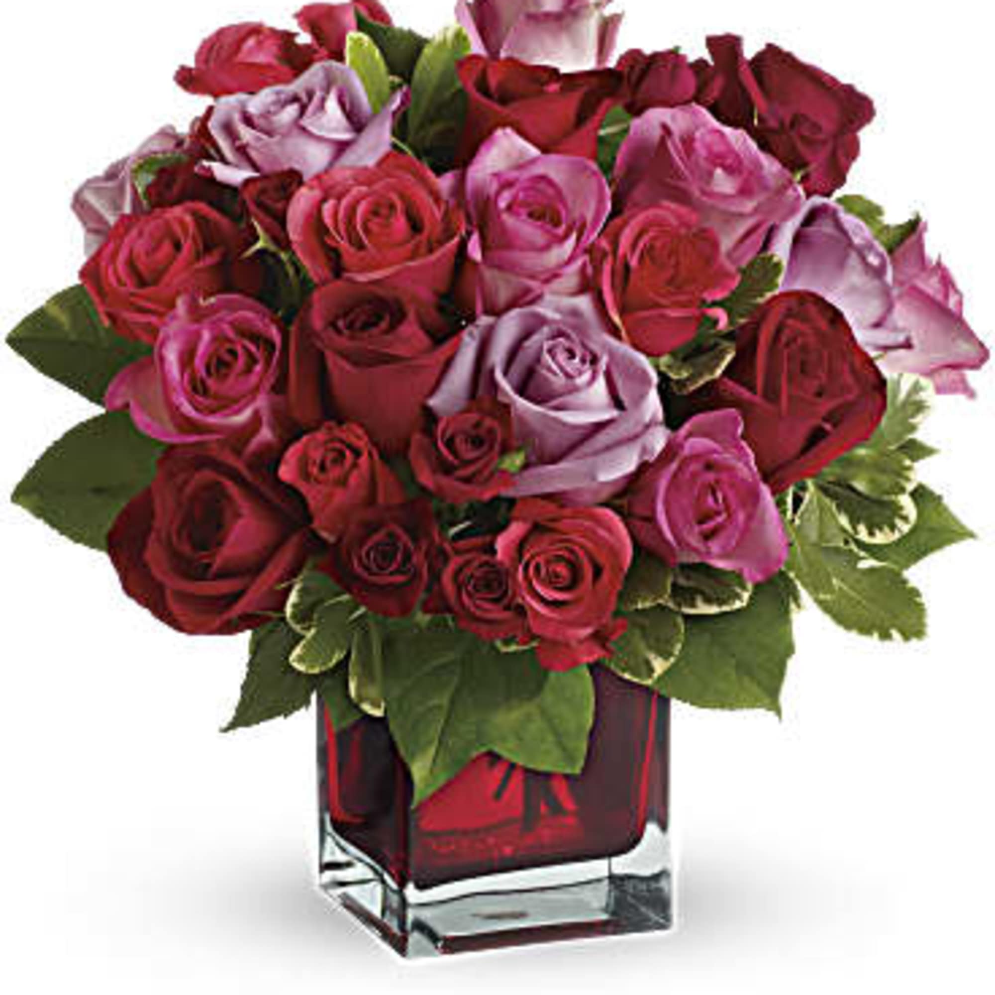 Bouquet of red and pink roses in a square glass vase
