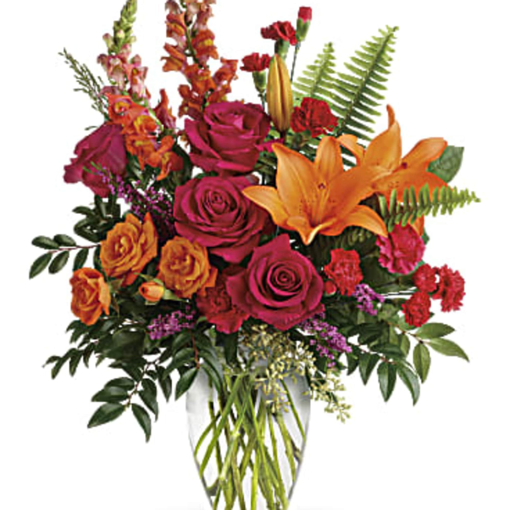 Bouquet of orange lilies and magenta roses in a clear glass vase