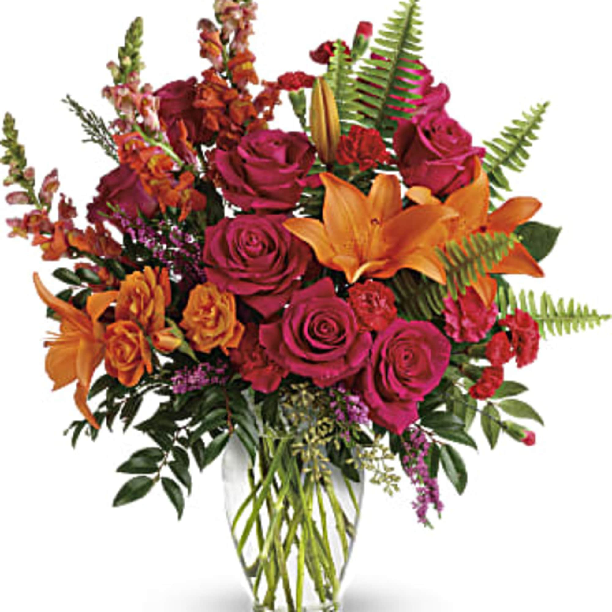 Bouquet of magenta roses and orange lilies in a clear glass vase