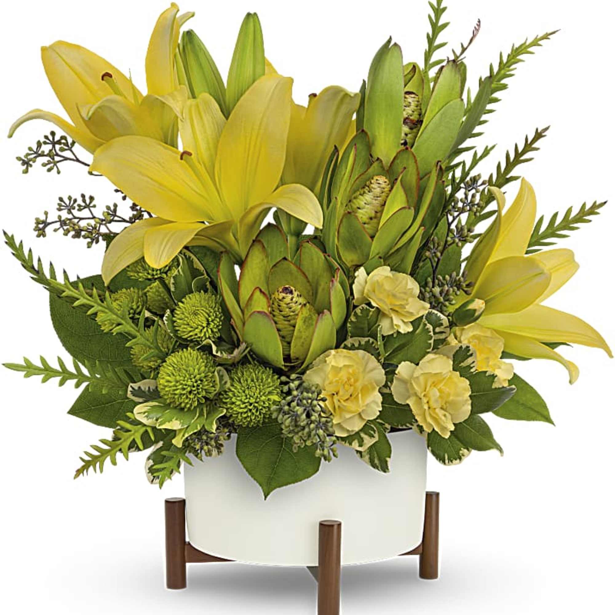 Yellow lilies and green protea in a white planter