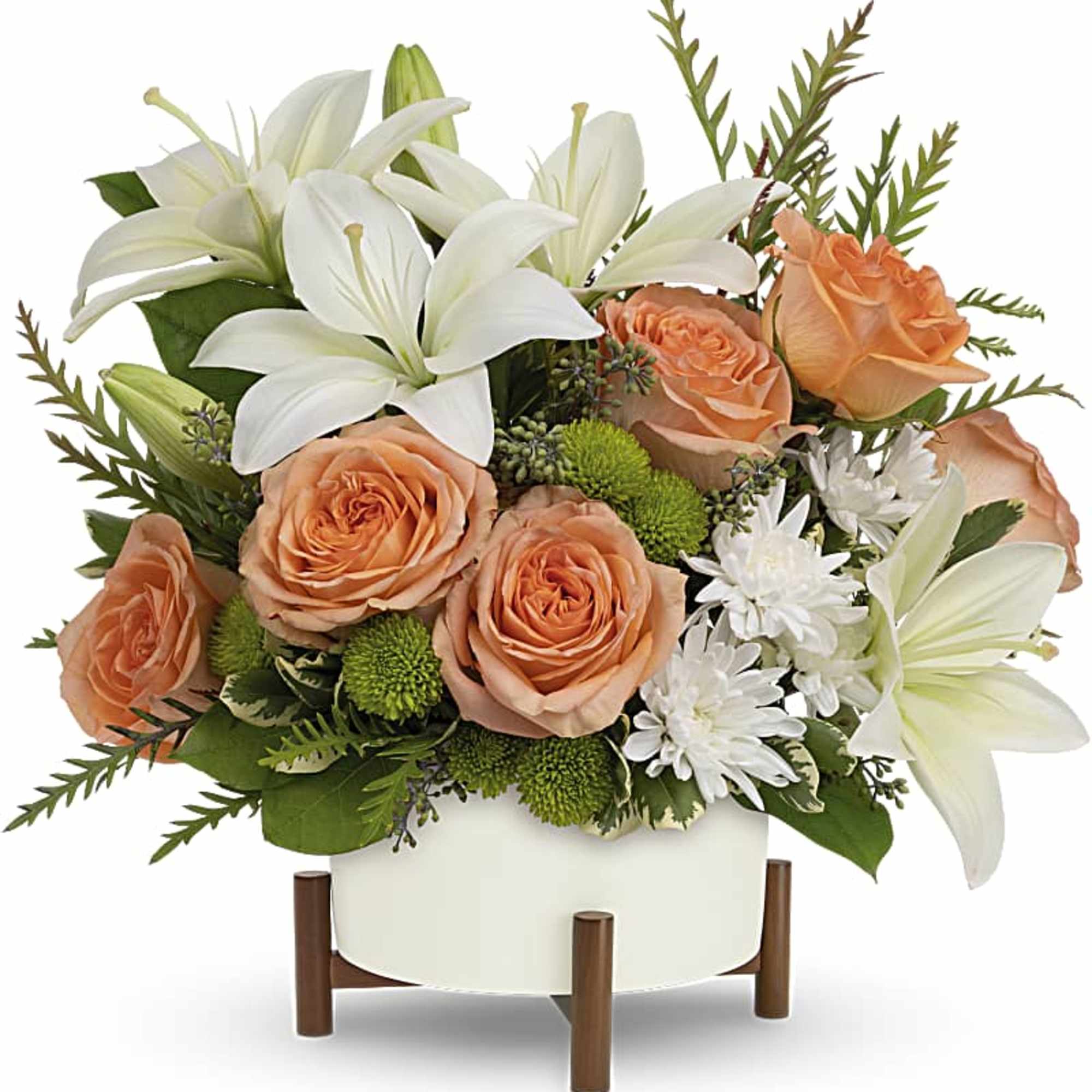 Peach roses and white lilies in a white vase on a wooden stand