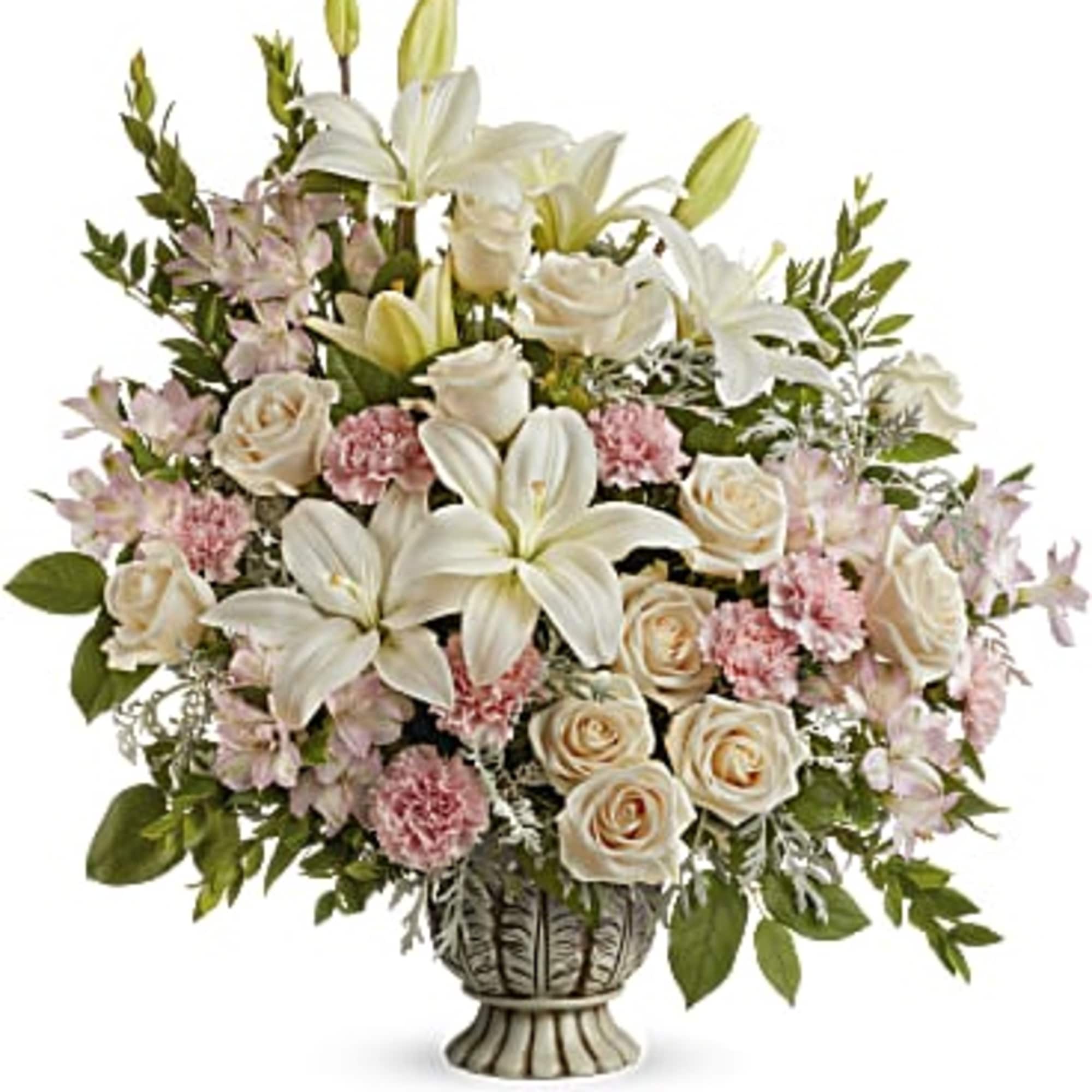 White lilies and cream roses in a decorative vase