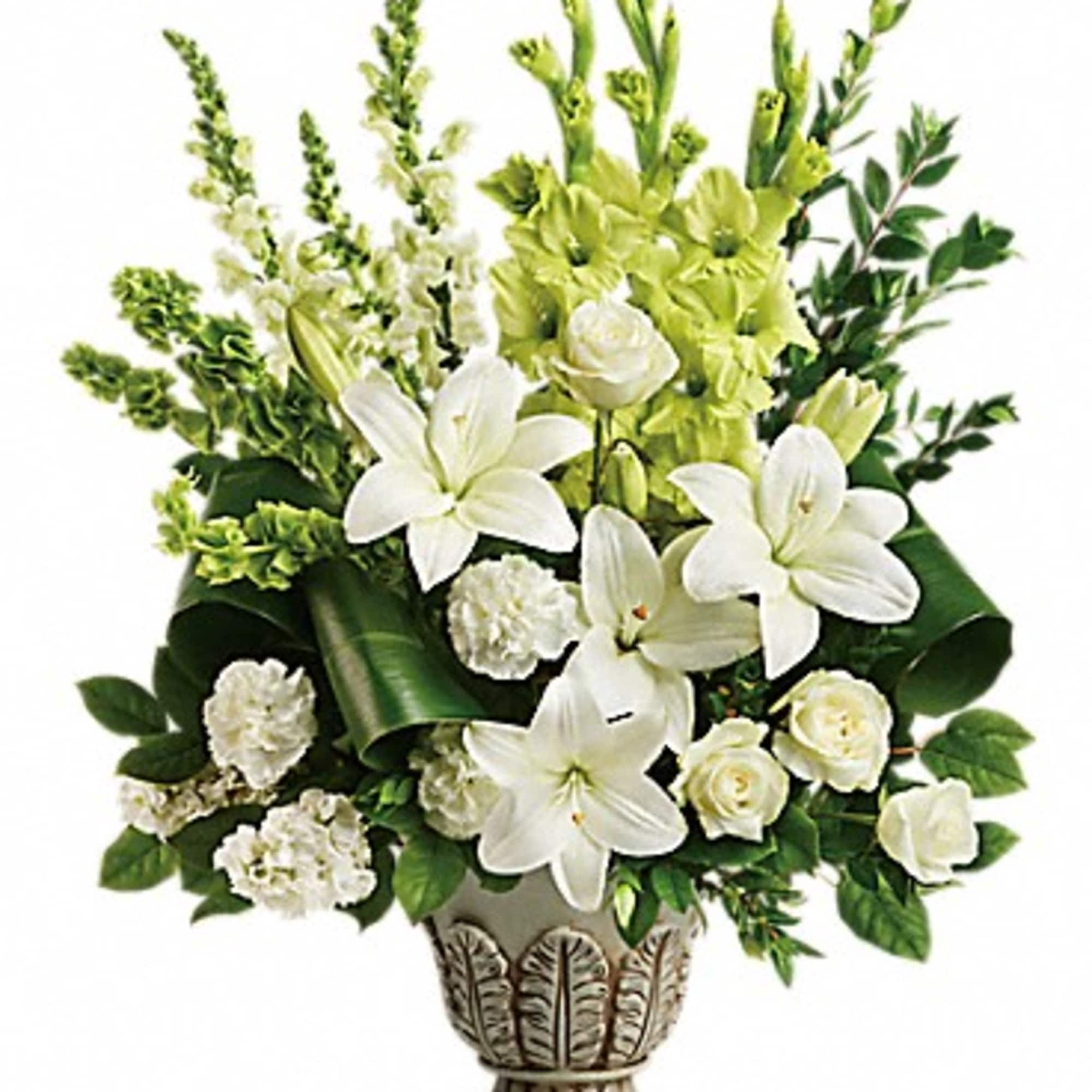 White lilies and roses in a decorative vase with green flowers
