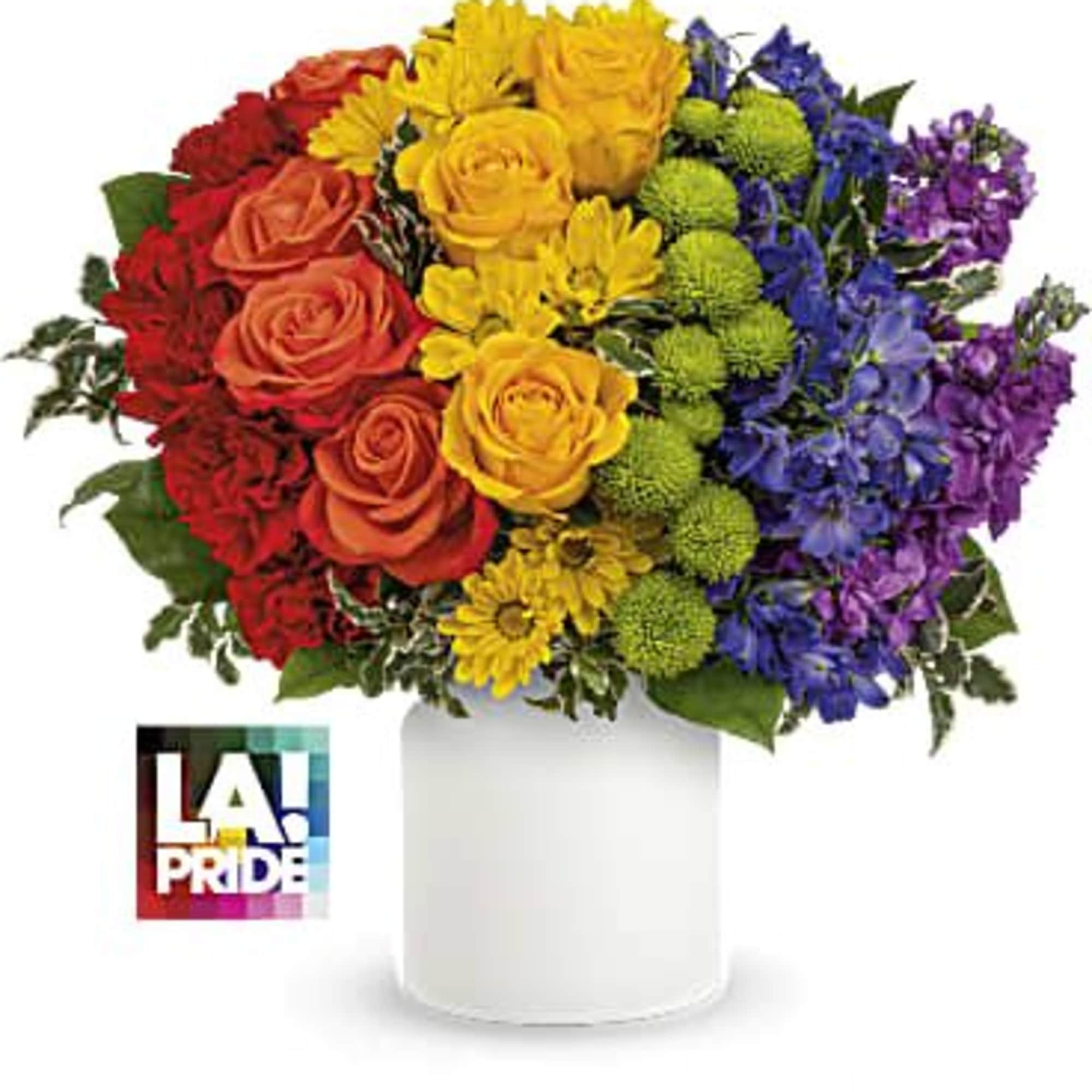 Rainbow bouquet of roses, daisies, and blue flowers in a white vase