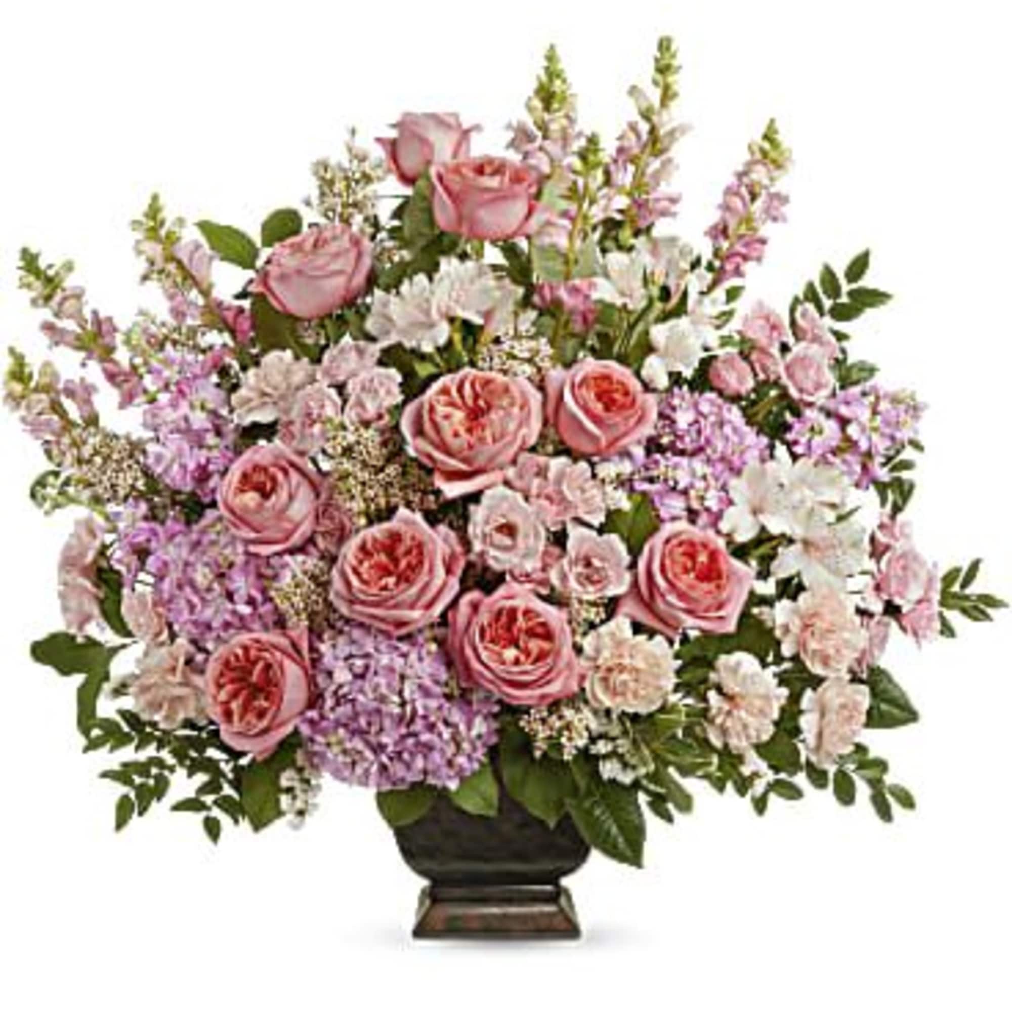 Pink roses and mixed pastel flowers arranged in a dark vase
