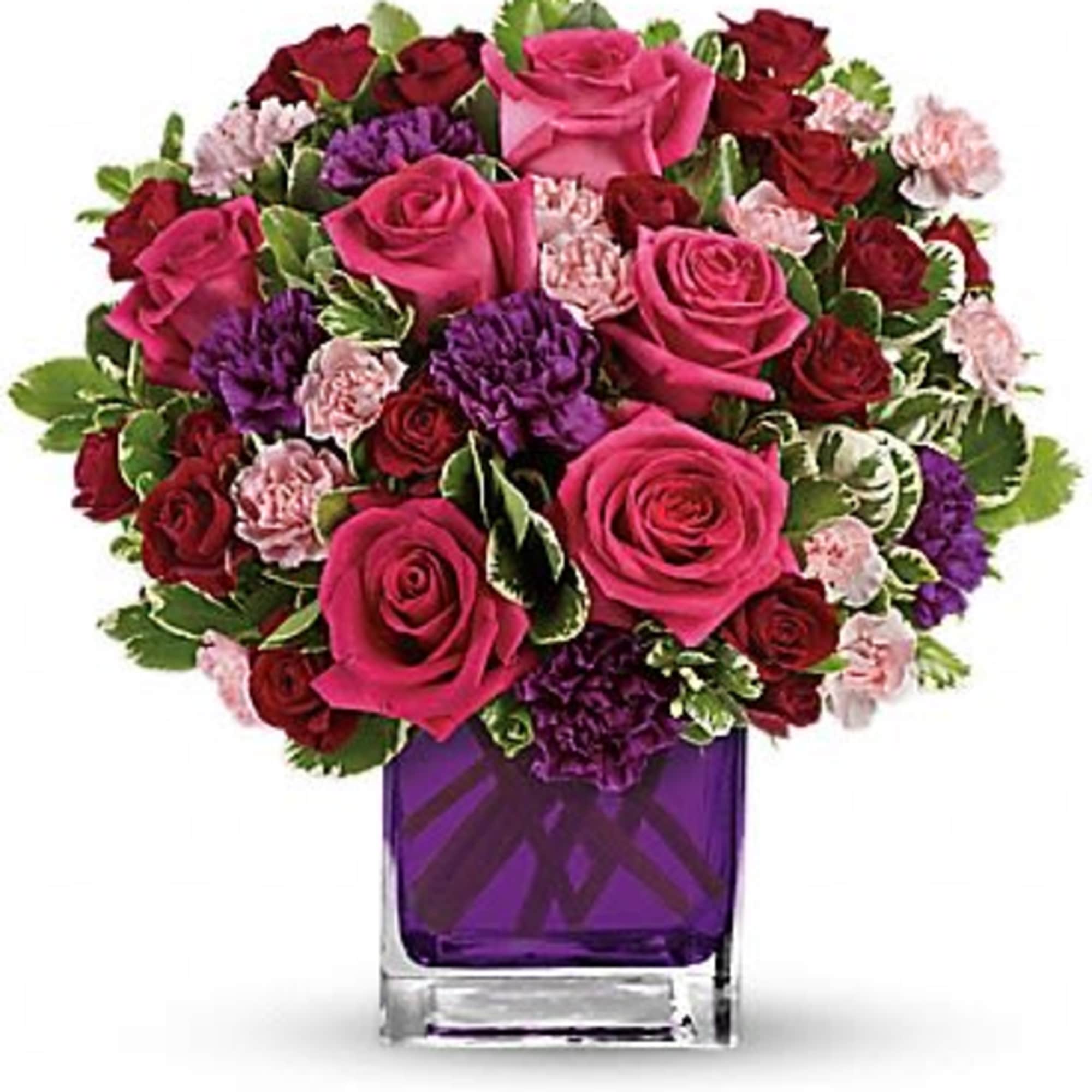 Pure romance. Hot pink roses and dark red spray roses are brightly