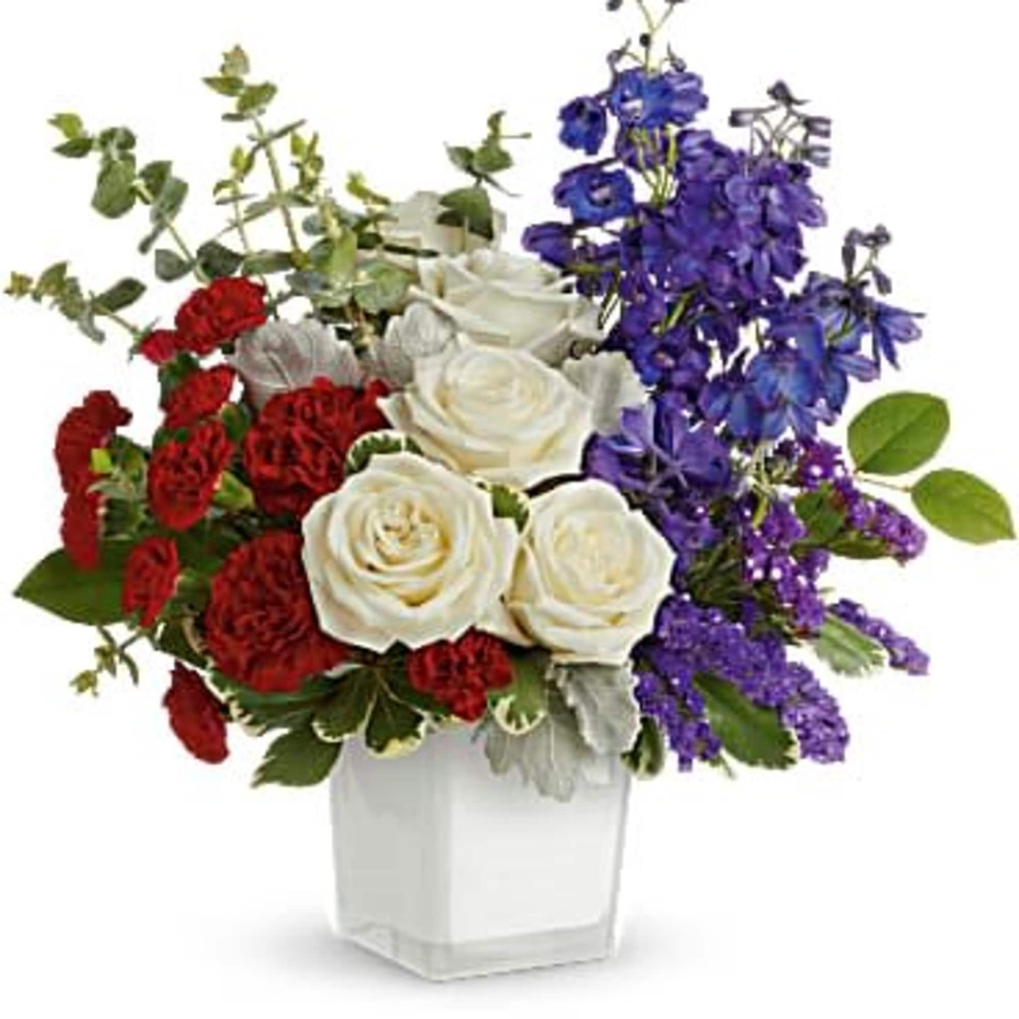 Bold clusters of red carnations and crisp white roses meet soaring blue
