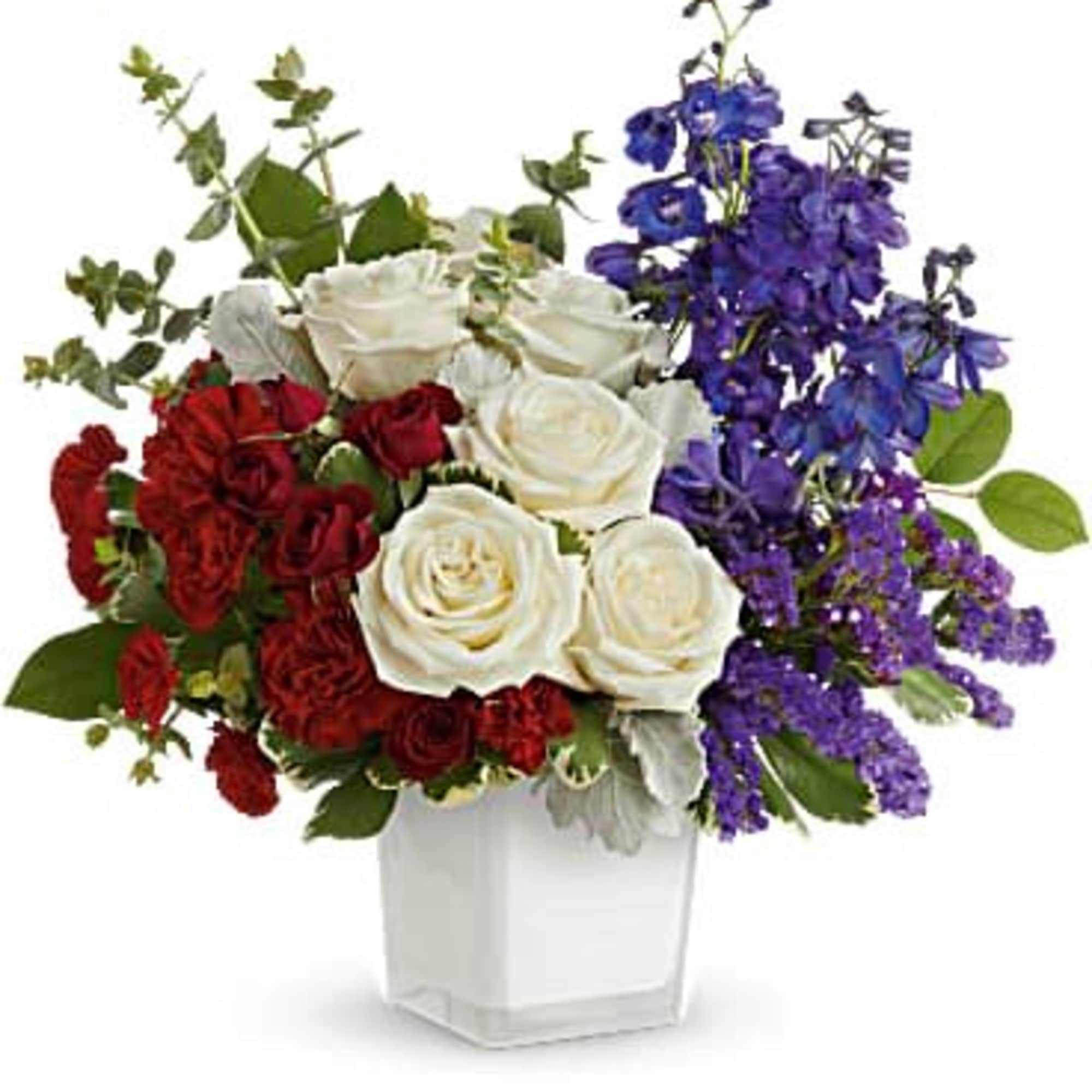 Bold clusters of red carnations and crisp white roses meet soaring blue