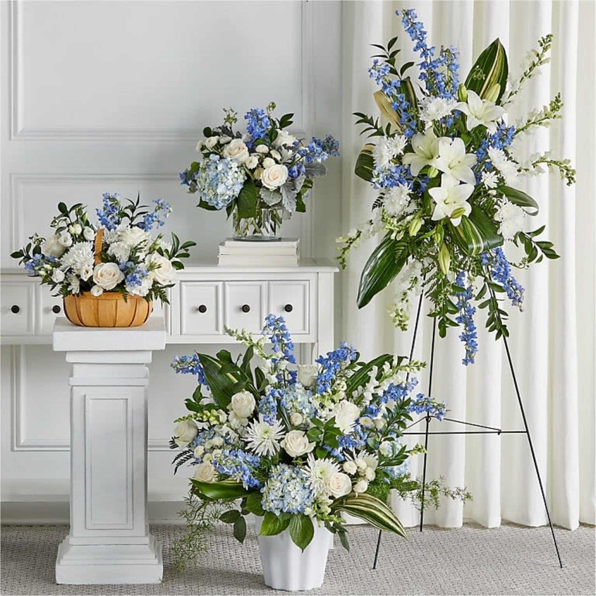 Soft blue delphinium spikes and pale hydrangea clusters meet classic white roses