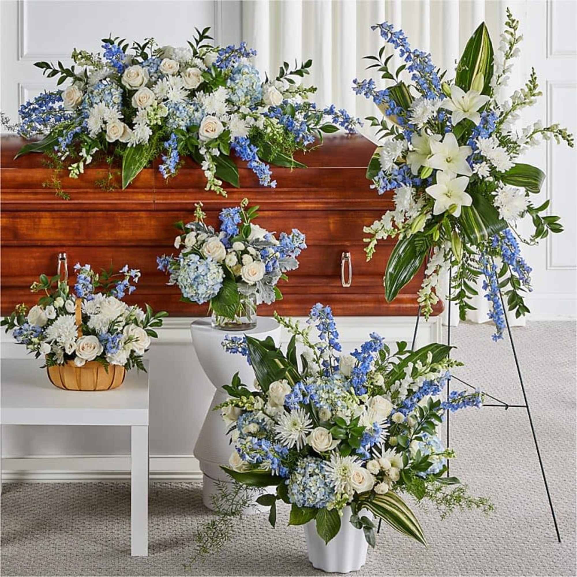 Soft blue delphinium spikes and pale hydrangea clusters meet classic white roses